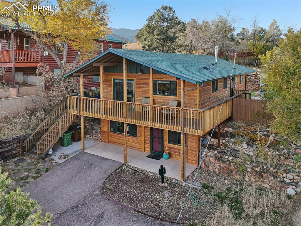 Welcome to this gorgeous, recently updated Manitou Springs home! This home is close to restaurants, downtown Manitou Springs, hiking trails and schools! as you pull up to this amazing home, you'll notice the large wrap around deck and the beautiful wood siding giving it true mountain home feel. The wrap around deck has plenty of sitting areas to enjoy the views! This deck also brings you around to the fenced backyard equipped with a hot tub, storage shed and newly laid pet friendly turf. As you enter the home through the front door you are met with natural wood flooring and an abundance of natural light coming through the windows and doors. The living room, dining room and kitchen are all open concept with a nice walk out from the dining area to the wrap around deck. The kitchen has a gas  stove, custom cabinetry, wine fridge, quartzite countertops and a breakfast bar, to name a few of the gourmet upgrades! Down the main level hallway is the primary bedroom, bedroom 2, laundry and a full bathroom. Near the full bathroom at the end of the hall has yet another walk out to the wrap around deck and backyard! The lower level boasts a bedroom with a sitting area, an office, a family room with gas burning fireplace, a storage closet that has a washer/dryer plug in and a 3/4 bathroom. The lower level also has its own access from the front of the home. Come check out this amazing, one of a kind Manitou home today!