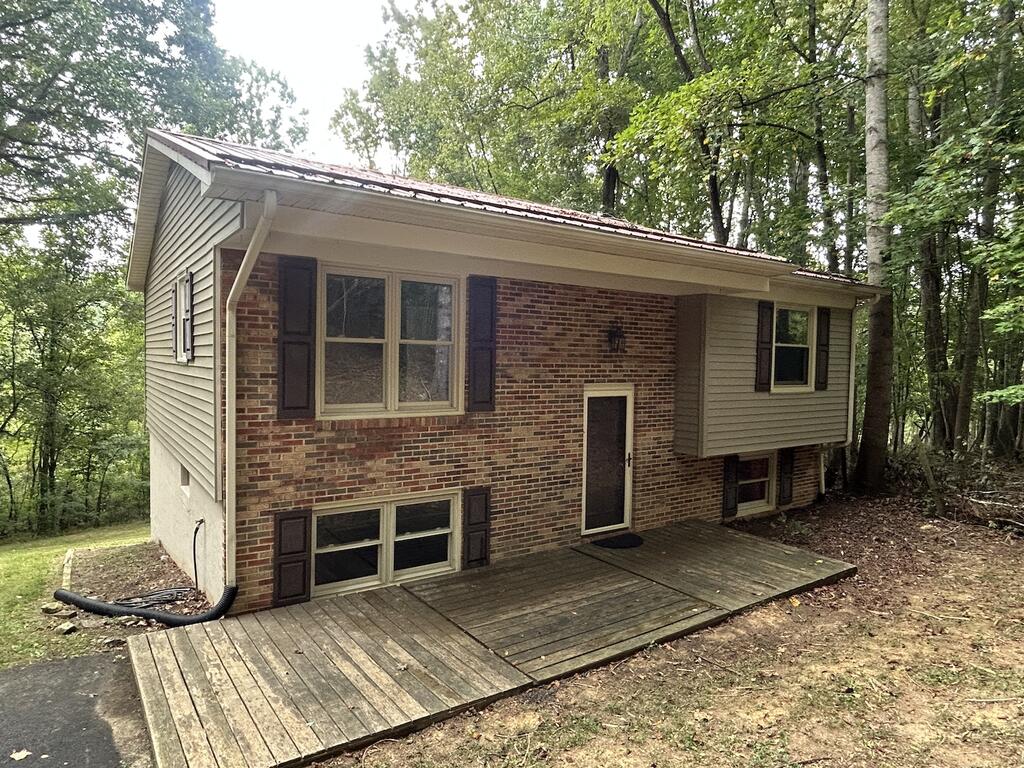 Privacy and space is what this 2-3 bedroom split foyer home offers at a hard price to match! Inside you will find an updated kitchen with plenty of cabinets, newer flooring, a spacious bath, and a large den (or 3rd bedroom) with french doors leading out to the back.  There is an unfinished basement part that has the washer and dryer and it could be easily made into living area if needed.   Located a short distance to Jefferson National Forest, Horse trails, Appalachian Trail and Dismal Falls This is a must see only minutes from I-77, grocery shopping and schools.  Lot is over 1/2 acre and is open/wooded. Driveway has plenty of parking and it is paved.  Call today for this deal!