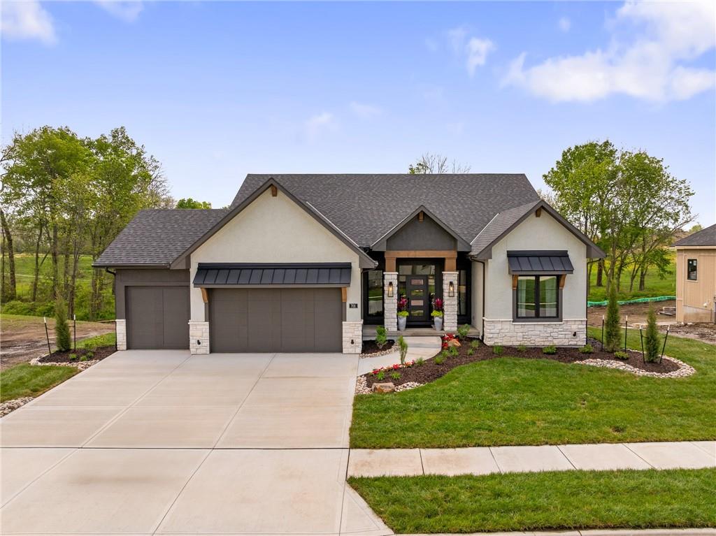 This popular "Expanded Windsor" reverse 1/2/ ranch floor plan by C&M Builders truly checks all the boxes both inside and out! Situated on one of Creekmoor's most beautiful golf course lots, it offers privacy while still providing a front-row seat to the action on the course and the occasional visit from local wildlife like deer. Inside, the home boasts a spacious primary suite with a large bath, walk-in closet, and direct access to the laundry room for added convenience. On the same level, you'll find another versatile room that can serve as a bedroom or office, along with a bath. The expansive great room features vaulted ceilings, a cozy fireplace, and a wall of windows that bring in tons of natural light. This opens up to a fantastic kitchen and dining area, perfect for hosting gatherings. Just off the dining area, a covered deck offers a tranquil spot to enjoy your morning coffee or unwind at the end of the day. The walk-out lower level is equally impressive, with two additional bedrooms, a bath, and a large family room with a wet bar—ideal for kicking back and watching your favorite games, especially cheering on the Chiefs! Please note that this home is a model home and is not currently for sale. The price may be adjusted when the home becomes available for purchase.
