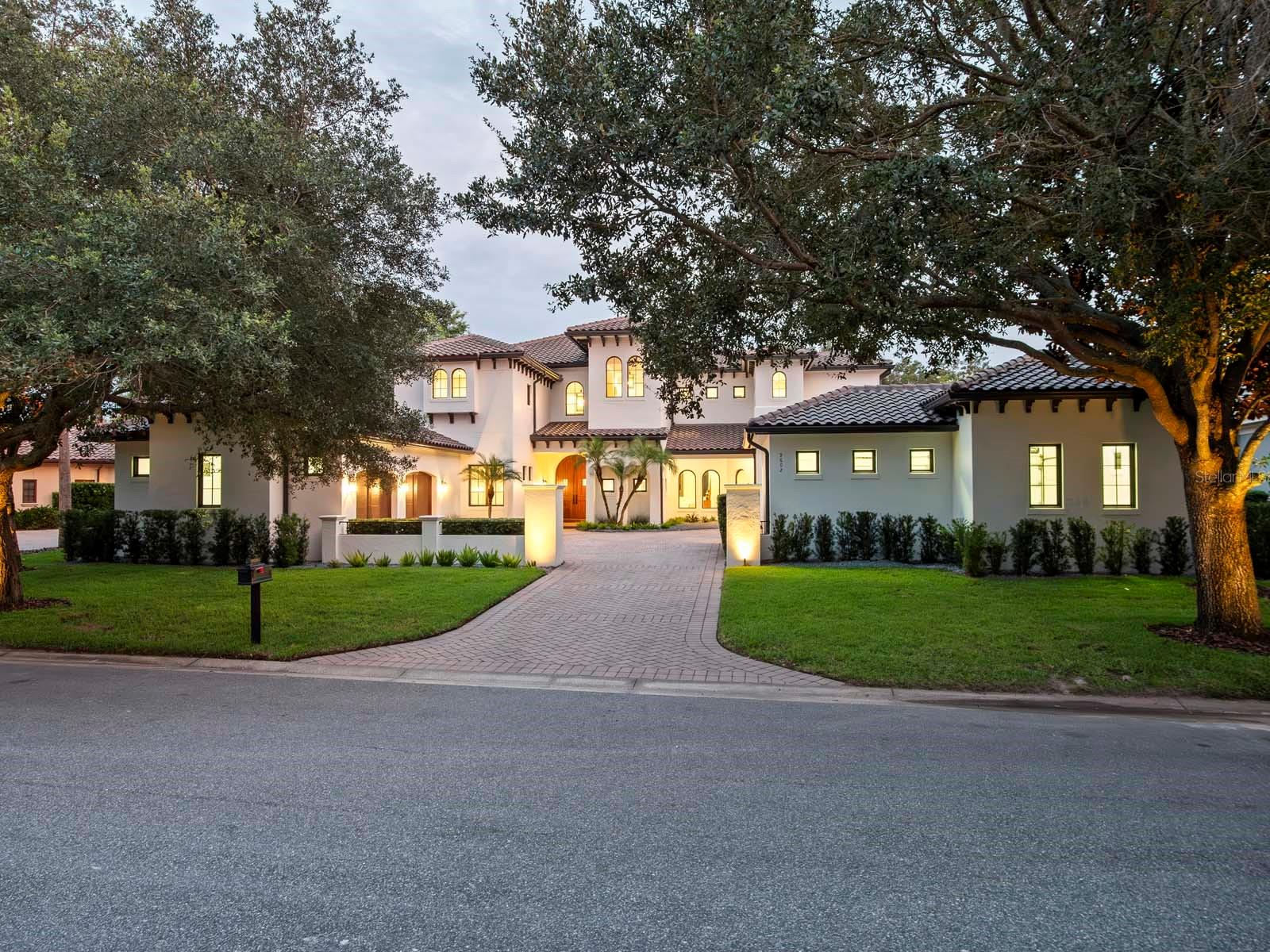 One or more photo(s) has been virtually staged. Nestled along the 12th fairway of Lake Nona Golf & Country Club's famed championship golf course, stunning panoramic fairway and water views provide the backdrop for this gorgeous estate within one of Central Florida’s most sought-after private communities. Originally built in a Mediterranean style, the residence has just undergone a comprehensive renovation by Akers Custom Homes, featuring an expertly reimagined floor plan, a new epicurean kitchen, remodeled bathrooms throughout, the addition of a second-floor laundry suite, and a fifth private ensuite bedroom. The exterior received a new roof, fresh exterior paint, Sierra Pacific windows and doors, and a newly designed saltwater pool and spa. 
Custom double doors open to the home’s welcoming foyer, which introduces the thoughtful floor plan where formal and casual living spaces are enhanced by natural light and golf course views. The elevated interior design strikes the perfect balance of sophistication and warmth with new European white oak hardwood flooring and custom cabinetry throughout, and Lutron lighting integration for intuitive whole-home control. The chef’s kitchen showcases an all-new Viking appliance suite, including a 48” dual-fuel range with six burners, griddle, and double ovens, a 48” built-in refrigerator, professional dishwasher, and matching hood. A center island with Kohler prep sink, a walk-in pantry and a breakfast nook complete the space.
The first-floor owner’s suite offers a serene retreat with dual walk-in closets, a reading nook, and direct access to the lanai. The spa-inspired bath highlights a freestanding soaking tub, custom vanities, and an oversized glass-enclosed shower. The second floor is comprised of three generously sized en suite bedrooms, a dedicated study/office, bonus/media room and access to an expansive covered balcony.  
Outdoor spaces are designed for entertaining and recreation, offering multiple golf course vantage points, a new saltwater pool and spa, and an integrated sports court with basketball hoop. Additional features include two expansive laundry suites, indoor and outdoor gas fireplaces, and garage space for 3 cars and 2 golf carts with built-in cabinetry, sink, and climate-controlled mini-split system.