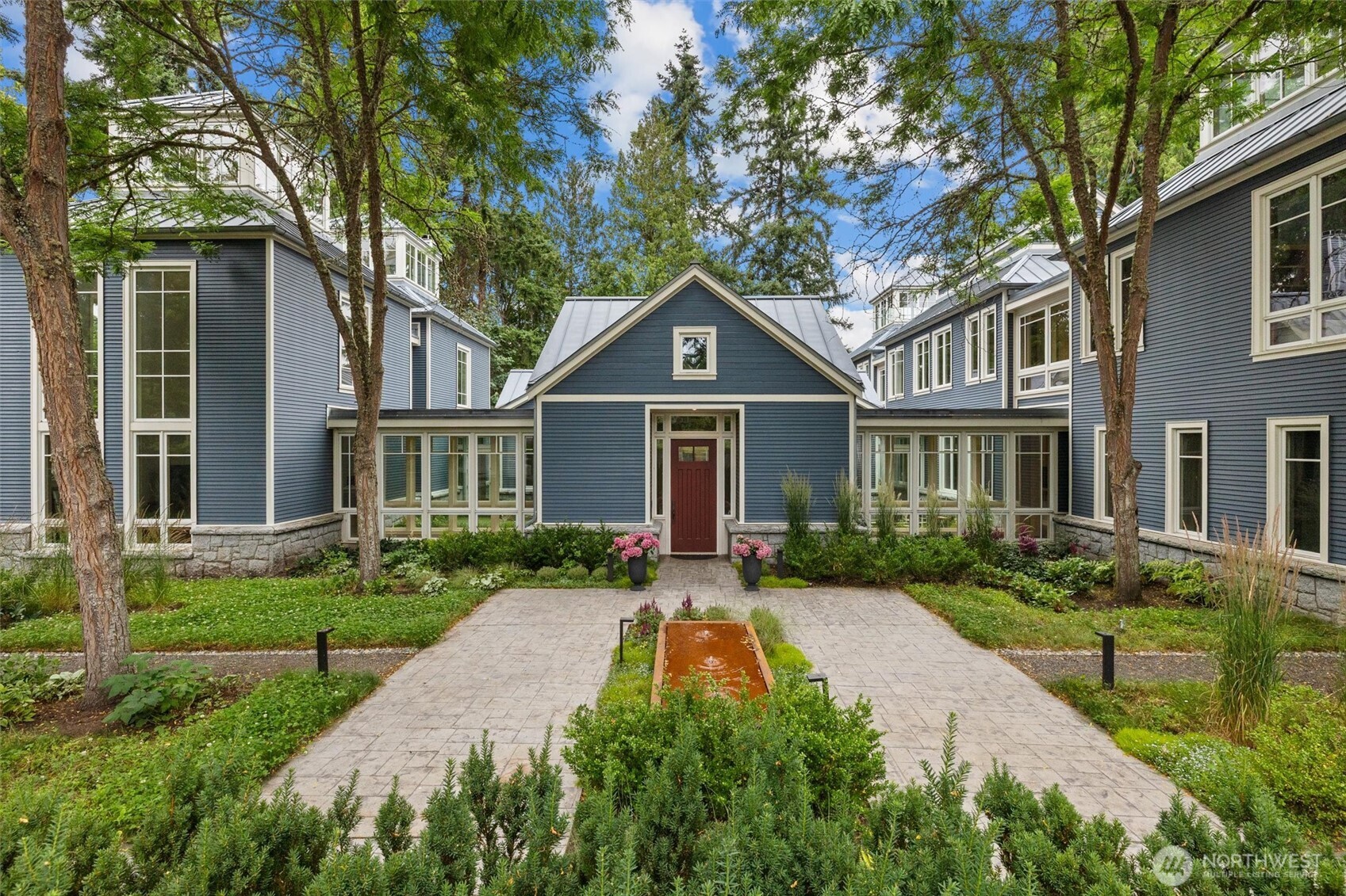 A rare opportunity for estate living with over 7,500 sqft on 120ft of high-bank Sammamish River frontage—complete with a 350 sqft dock and boat lift offering easy access to Lake Washington. Set on a gated 1.15 acreage lot, professionally landscaped from front to back, this architectural residence built by The Roberts Team features soaring windows, 30 ft tall vaulted ceilings, sunlit interiors, and seamless indoor/outdoor flow. Enjoy a high-end chef’s kitchen, home theater, 2,000-bottle wine cellar, putting green, manicured paths, ADA accessible suite on main level, three-car garage, whole-home audio, fire-pits, and a detached 1-bedroom/1-bath guest carriage house. A private waterfront retreat designed for scale, comfort, and timeless style.