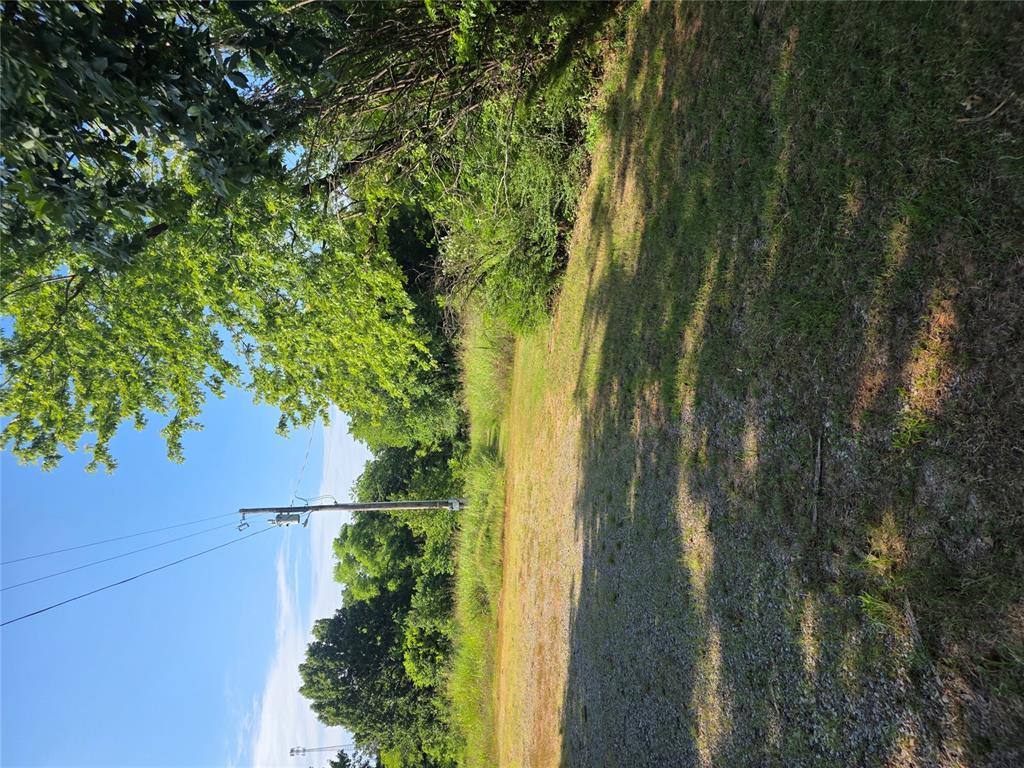 This beautiful 1.69 acres has a foundation for a trailer home and access to utilities. It has fruit trees and and a small office building anchored to part of the trailer foundation. It is really a beautiful place.