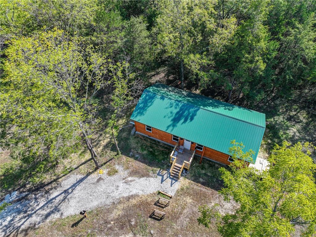 House for sale Collins Missouri Discover your private retreat in the heart of the Midwest. Sitting on approximately 13+/- acres of serene, wooded land (survey in process), this newly built 1,200 sq ft home in Collins, Missouri offers the perfect blend of rustic charm and modern efficiency. Tucked away just off Highway 54, this thoughtfully designed residence features a warm, inviting layout with two generously sized bedrooms and two full bathrooms. The living space is enhanced by rustic finishes that echo the tranquility of the surrounding landscape. Built for comfort and sustainability, the home is efficiently heated and cooled by mini-split systems, keeping utility costs low year-round. It also includes a private septic system and shares a well with only one neighboring property—providing both independence and reliability. Land for sale St. Clair County Missouri The property also features a spacious 30x40 shop, complete with partial living quarters—offering incredible potential for guest accommodations, a hobby workspace, garden prep area, fish-cleaning station, or anything else your imagination can dream up. Whether you're envisioning a hobby farm, a hunting retreat, or a full-time rustic escape, this property is ready to bring your vision to life.Conveniently located in Collins, Missouri, you're just a short drive from Bolivar, where you'll find essential amenities including a hospital, grocery stores, and dining options. For even more access, Springfield is just an hour away, and Kansas City is about 90 minutes.Outdoor enthusiasts will love the proximity to Truman Lake and Pomme de Terre Lake, both offering excellent fishing, boating, and camping opportunities. Plus, with thousands of acres of nearby Corps of Engineers land, you'll have no shortage of space for hunting, hiking, and exploring.
