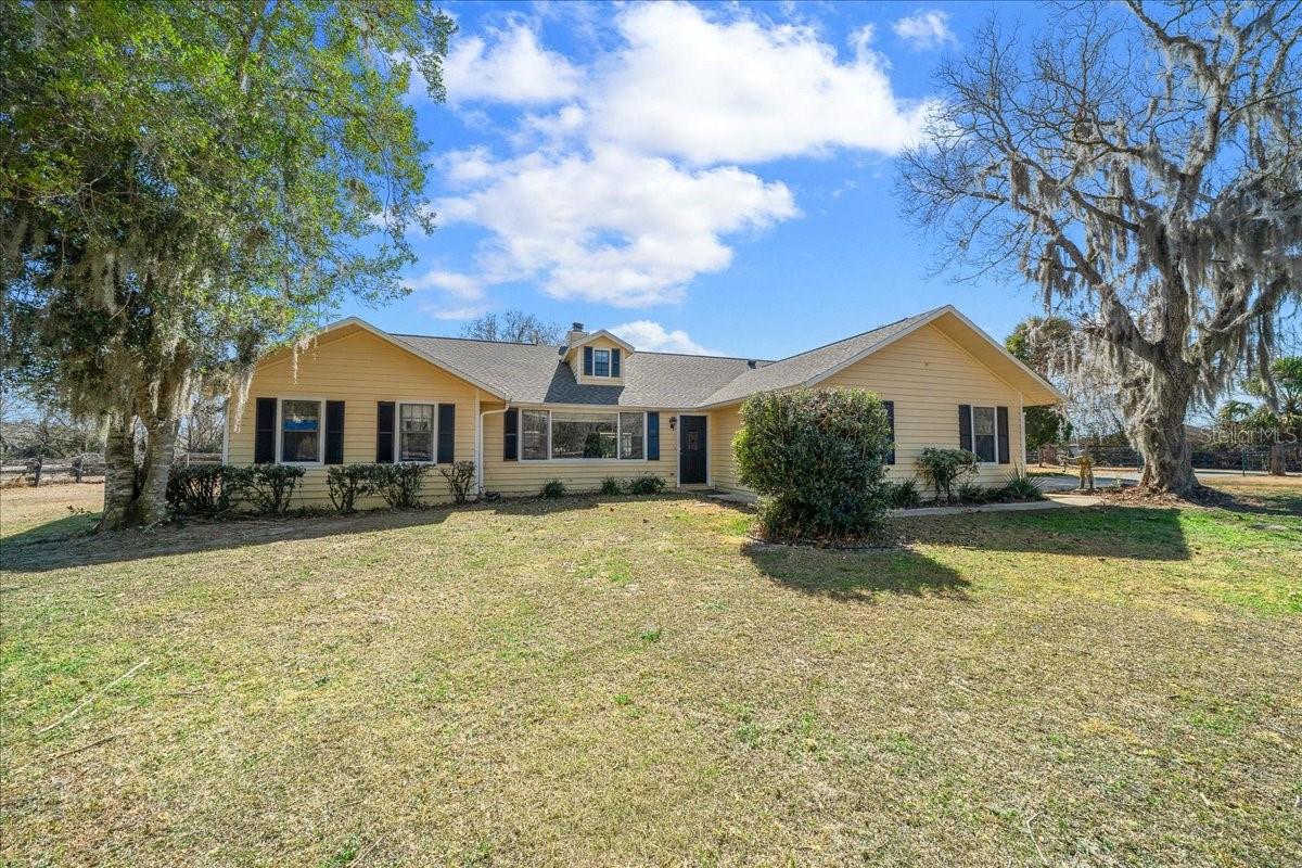 "IF YOU CAN DREAM YOU CAN DO IT " 6.85 private acres on a beautiful quiet Equine gated street just 5 minutes from the Florida Horse Park, 8.5 Miles from WEC, this property offers a great opportunity for buyers looking to create their own farm or country retreat. Situated at the end of scenic road, the 6.85 acres is high and dry  room for a arena with peaceful views at the end of the cul-de-sac for added privacy. The home has had some recent improvements, including a newer roof, newer vinyl flooring in the living and dining areas, and updated tile in both bathrooms. Well-constructed outbuildings provide useful space for horses, 2 Barns, 6 stalls, equipment storage, or workshop needs.. 30 Amp RV hookup. With its desirable location, beautiful useable acreage, and solid foundation, this property is well suited for someone ready to add their own vision and value. Call for Appt today. A great opportunity in an amazing location to invest, improve, and enjoy.