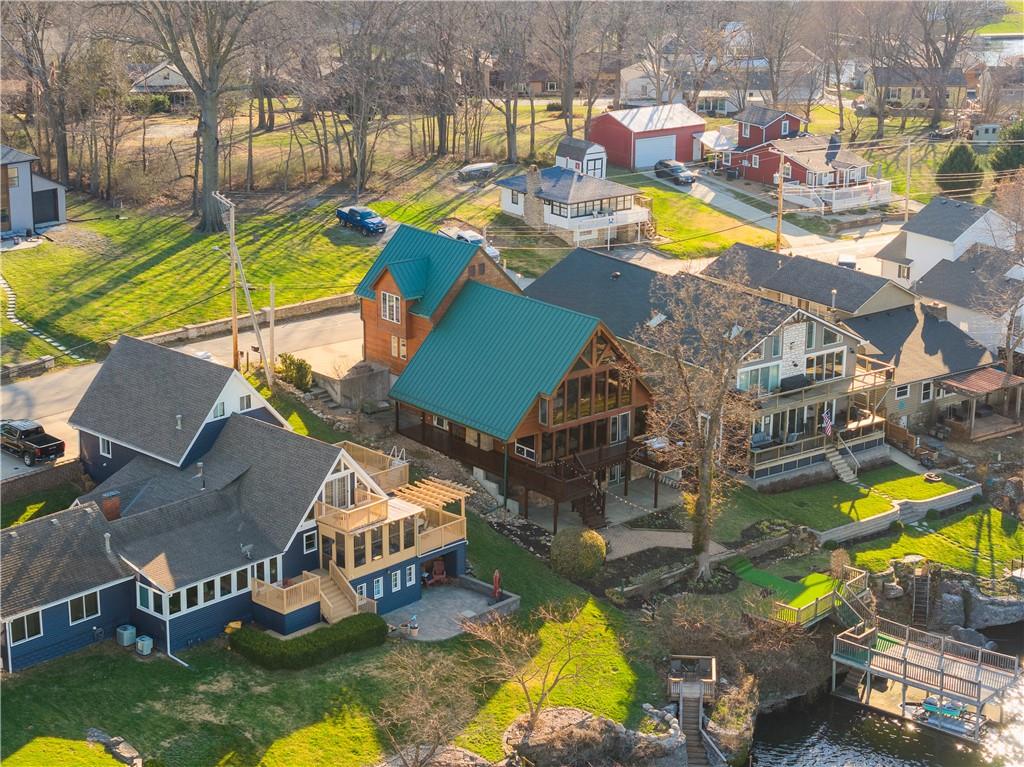 Some properties offer a place to live. This one offers a way of life.Nestled on the shores of Lake Tapawingo, Cabin Tapawingo is a rare lakefront sanctuary where sweeping 180-degree water views, effortless entertaining, and the timeless charm of an A-frame retreat come together in perfect harmony. From front-row Fourth of July fireworks to peaceful mornings with sunlight dancing across the water, this home is built around unforgettable moments.A Home Built for GatheringWith 4 bedrooms, 2 additional flex sleeping spaces, and multiple generous living areas, there’s room for everyone. A fully self-contained mother-in-law suite with its own kitchen and living space offers the perfect balance of togetherness and privacy for guests or extended stays.A Primary Suite That Redefines Waking UpEnjoy panoramic lake views every morning from the comfort of your primary suite, complete with ample closet space and a stunning 180-degree vista year-round.Entertain on Every LevelThe walk-out lower level features a full bar, restroom, and direct lake access, creating seamless indoor-outdoor living. Outside, your private dock with an upper tanning deck is made for long summer days on the water.Move-In Ready, Timeless CharacterFreshly restained siding and decking enhance the home’s classic lake cabin charm. With a two-car garage, parking for 4+ vehicles, and just 22 minutes to downtown Kansas City via I-70, you get the best of both worlds.The OpportunityTrue lakefront homes like this are rare. Cabin Tapawingo is more than a home, it’s a legacy property and a place to gather for years to come.Your lake life starts here.
