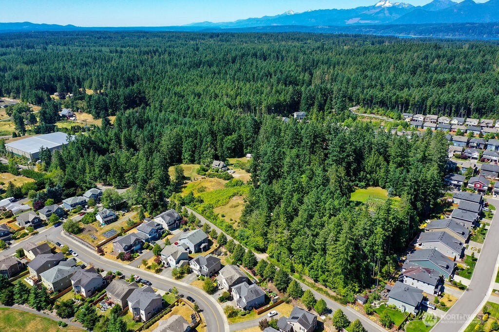 Outstanding 9.72-acre residential development opportunity in Poulsbo. Expired technically complete preliminary application had been submitted and advanced to near-final plat for a 40-lot single-family subdivision with conceptual plans for grading, utilities, stormwater, landscaping, and tree retention. Zoned Residential Low (4–5 DU/acre) with average lot sizes of 8,044 SF. Water and sewer available at frontage. Nestled between three residential communities and minutes from Olympic College, future Parks & Rec campus, Fairfield Inn, Home Depot, and more. Quick access to Hwy 3/SR-305. Near new Pickleball Kingdom. Surrounded by growth—ideal for a signature neighborhood. Do not access property—residences on site.