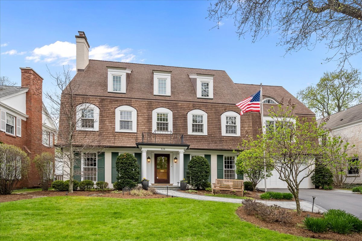 Set on a coveted street in Kenilworth, this impeccably maintained home pairs timeless architecture with an exceptionally rare floor plan featuring six bedrooms, including five on the second level. Thoughtfully expanded and extensively renovated, the home blends classic detailing with a tailored, city-chic aesthetic across every level. A gracious foyer introduces dramatic entertaining spaces including a striking living room with fireplace and an elegant formal dining room. The butler's pantry connects seamlessly to the custom kitchen, featuring high-end appliances, oversized island seating, and clean-lined finishes, all overlooking the expansive professionally landscaped grounds. The sought-after open floor plan flows effortlessly through the breakfast area and into the family room, creating a polished yet highly functional living space. A private first-floor office with custom built-ins is discreetly tucked away. Additional functional spaces include a spacious mudroom, first-floor laundry, and attached two-car garage. The second level features five bedrooms, including a stunning primary suite with two walk-in closets and a luxe bath with walk-in shower, soaking tub, and dual vanities. One secondary bedroom includes an ensuite bath and walk-in closet, while three additional bedrooms share a well-designed double Jack-and-Jill bath arrangement. The show stopping third-floor addition introduces over 1,200 square feet of architecturally significant living space with sweeping ceiling heights and a distinctly loft-inspired, city-chic sensibility. The level includes a recreation room with kitchenette, exercise studio with reinforced soundproof flooring, full bath, and additional bedroom or flex space. The lower level continues the home's impressive scale with a large recreation room, wet bar, second laundry room, and exceptional storage.  Professionally landscaped grounds extend the living space outdoors with a sport court, bluestone terrace, built-in outdoor kitchen, custom firepit, and multiple entertaining areas integrated throughout the property.  The thoughtfully executed renovation and expansion by Chip Hackley Architects includes the third-floor addition, new primary suite,  mudroom and first-floor laundry, bluestone patio, outdoor kitchen, sport court,  window replacement throughout, updated electrical and plumbing systems, and renovated lower level. Throughout, the home reflects a rare combination of architectural integrity, modern functionality, and polished design in one of the North Shore's most sought-after communities.