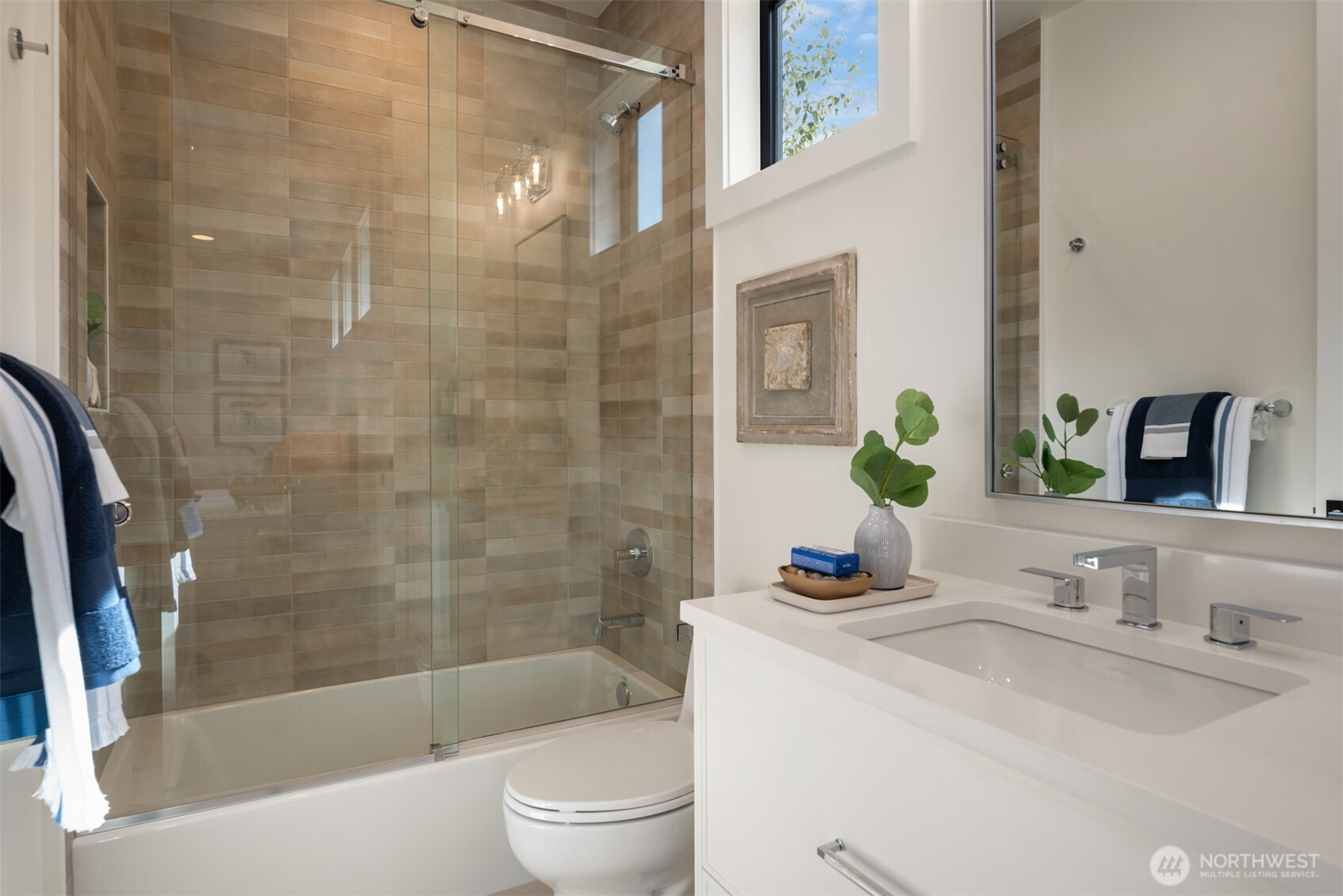 Serene bath featuring a soaking tub and tiled shower.