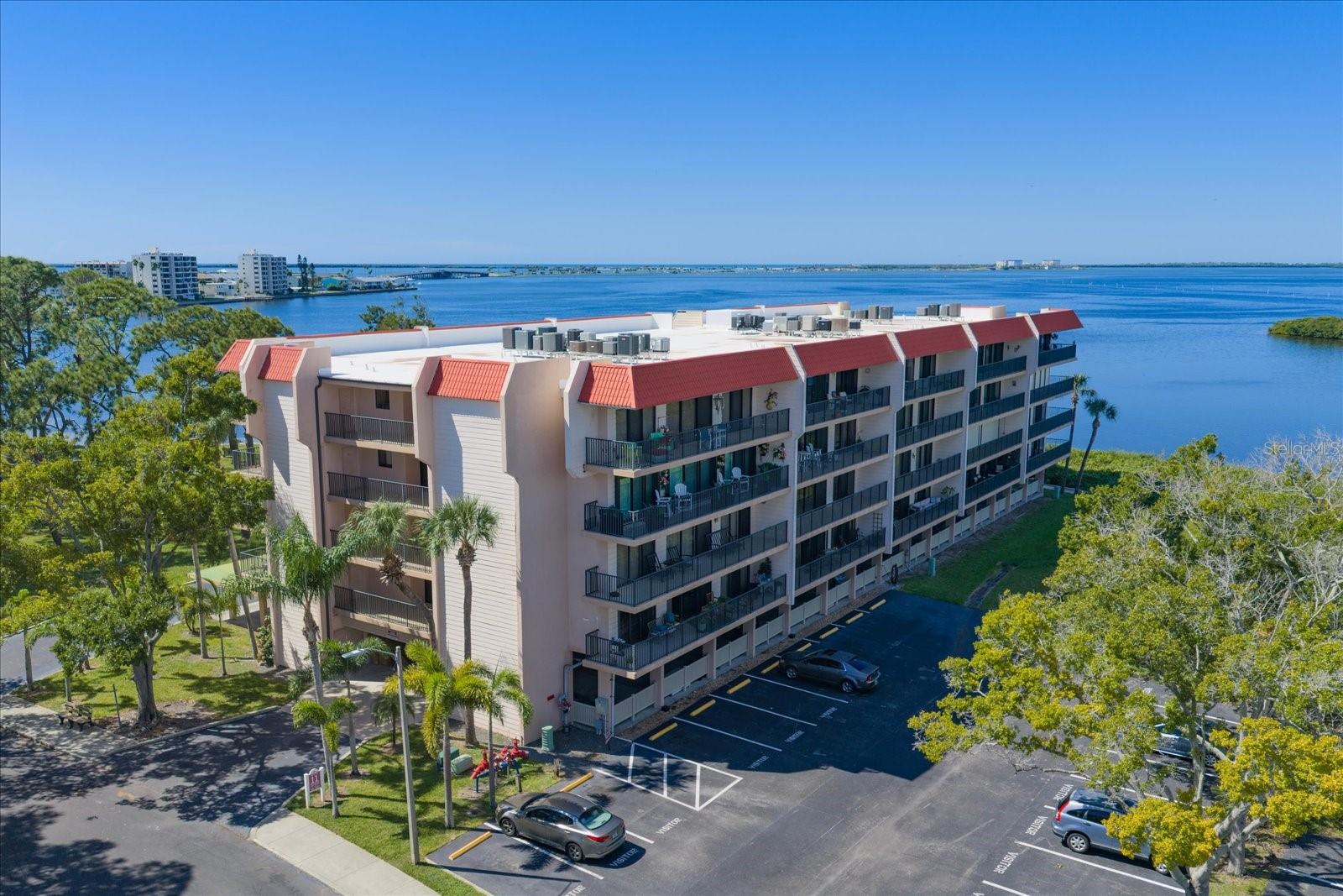 EXPANSIVE, UNOBSTRUCTED WATERFRONT VIEWS IN BEAUTIFUL DUNEDIN! Experience the allure of Florida’s Gulf Coast from this beautifully updated waterfront residence, showcasing sweeping views of the Gulf and Intracoastal Waterway. The approximately 225 square feet of balcony space provides a private vantage point for breathtaking sunsets, tranquil water views, and refreshing coastal breezes. The thoughtfully updated interior blends contemporary appeal with inviting comfort. An open concept design is complemented by vinyl plank flooring, recessed lighting, and a well-appointed kitchen featuring granite countertops, wood cabinetry, stainless-steel appliances, and generous preparation space. Custom-built closet systems throughout the residence provide tailored organization and maximize storage, while a whole-house water treatment system adds another desirable layer of everyday comfort. An interior laundry room offers the convenience of having laundry facilities right at home. The spacious primary suite features a walk-in closet with custom built-ins, a private ensuite bath, and direct access to the balcony. The second bedroom enjoys beautiful water views and its own balcony access, creating an inviting retreat for guests or a sophisticated home office. Adding exceptional value and convenience, the guest bathroom features an approximately $20,000 walk-in tub, a notable upgrade that enhances bathing comfort and accessibility. Beyond the residence, an impressive collection of waterfront amenities creates a distinctly resort-inspired lifestyle. Enjoy access to a private beach, waterfront park with barbecue areas, heated swimming pool, kayak storage, tennis and pickleball courts, and a clubhouse complete with a fitness center, library, and billiards. An elevated stilt building and additional storage options, including a bike room and communal storage on the residential floor, further complement the property. Situated across from the Pinellas Trail and convenient to the Dunedin Causeway, Honeymoon Island State Park, and Caladesi Island, outdoor recreation and natural beauty are always close at hand. Explore the boutiques, acclaimed dining, craft breweries, and golf courses that make downtown Dunedin such a beloved destination. A compelling blend of panoramic waterfront views, thoughtful upgrades, exceptional community amenities, and the relaxed sophistication of Gulf Coast living.