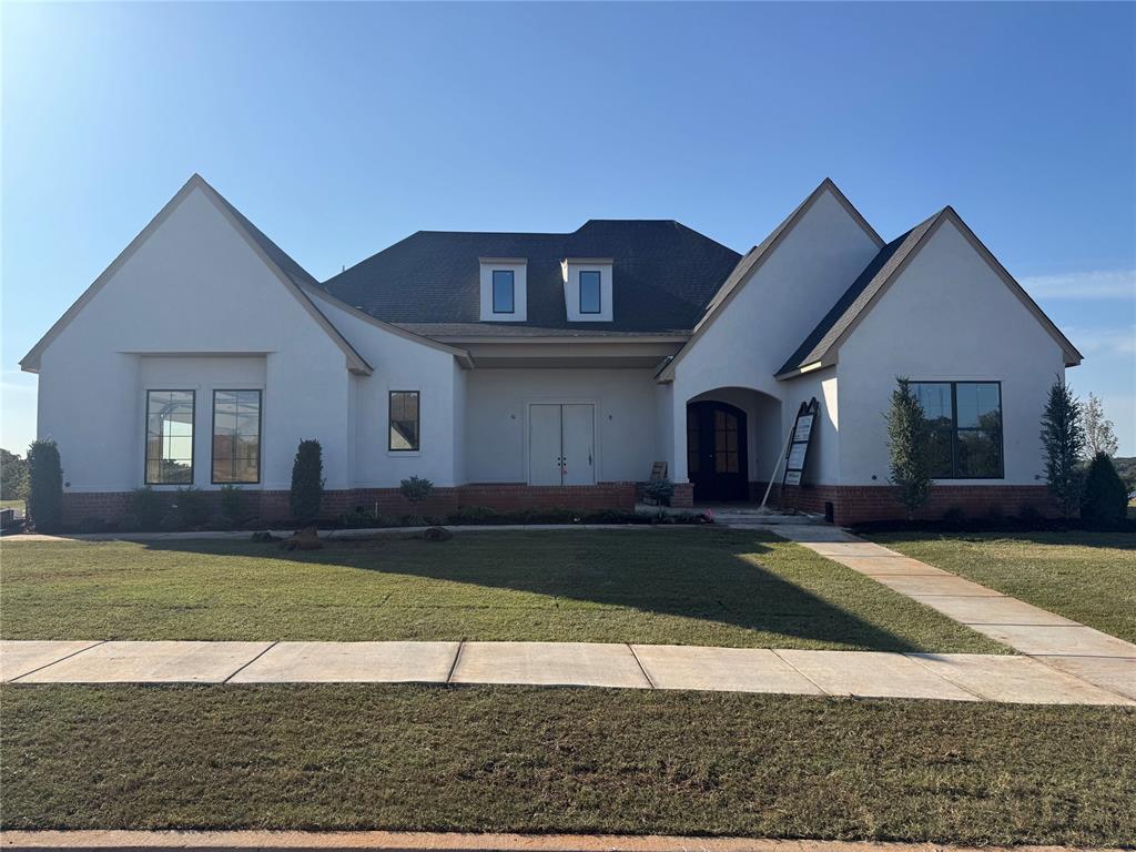 Welcome to 9400 Millstone, an elegant new construction tucked inside the gated community of Somerset Ridge in Edmond. This timeless home blends European-inspired architecture with modern design and function. Featuring high-end finishes, a thoughtful layout, and warm natural light, this home is being crafted for both comfortable living and stylish entertaining. With its steep-pitched rooflines, curated landscaping, and striking curb appeal, 9400 Millstone sets the tone for refined, luxury living. Somerset Ridge is Edmond’s newest premier development, designed for those seeking a tranquil lifestyle with easy access to city conveniences. This exclusive, gated neighborhood offers expansive greenbelt views, winding streets, and a peaceful, elevated feel that sets it apart. Residents will enjoy a sense of privacy and serenity, all within minutes of top-rated schools, shopping, and dining, including a Whole Foods coming to I-35 and Covell. Whether you’re enjoying sunsets from your patio or taking a walk through the scenic surroundings, Somerset Ridge is a retreat worth calling home.