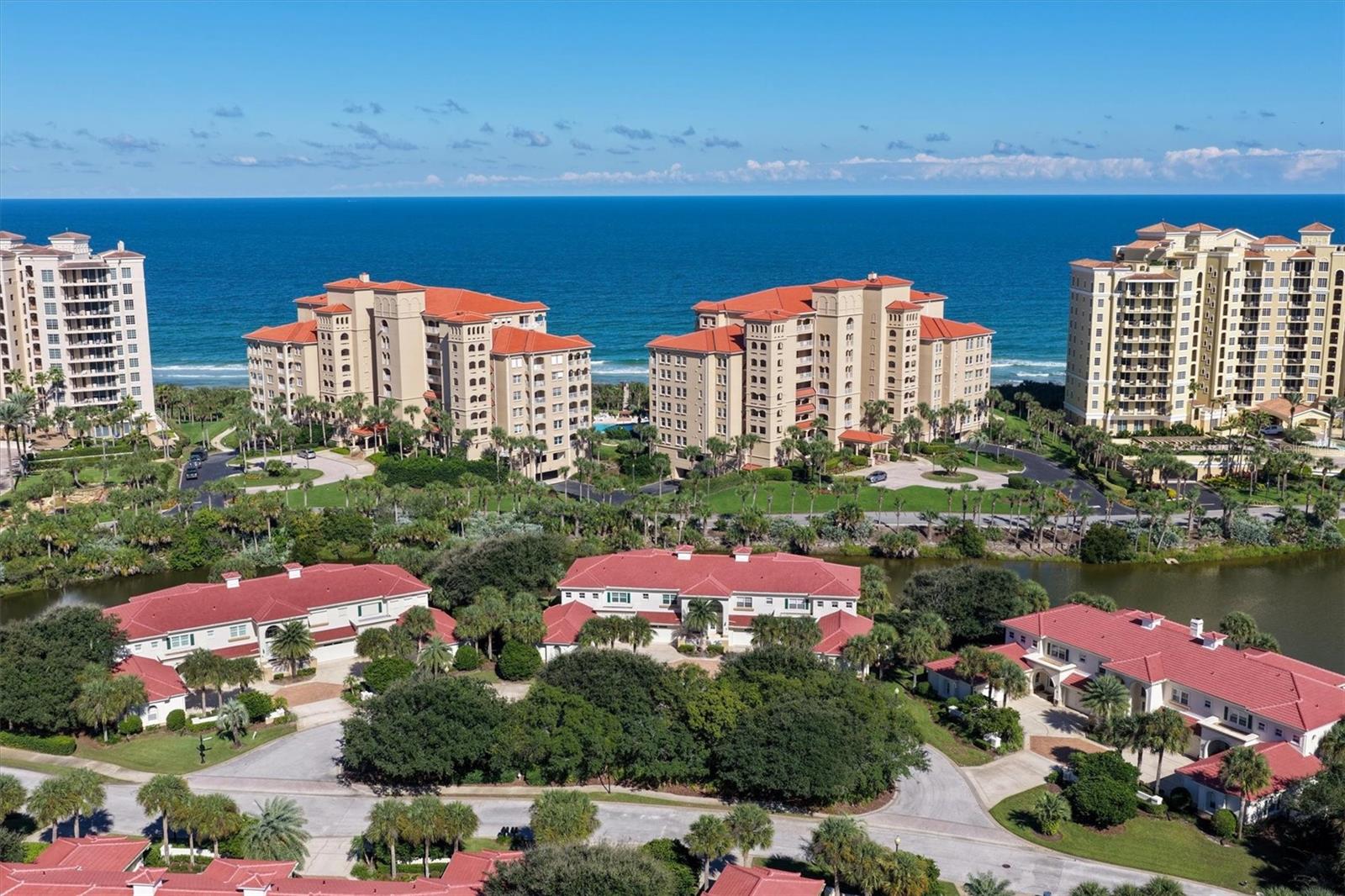 Discover coastal luxury living at 13 Viscaya Lane, nestled within the prestigious private oceanfront community of Hammock Dunes. This beautifully maintained residence offers 2 bedrooms, 2.5 bathrooms, a den (potential 3rd BR) and 2,186 square feet of thoughtfully designed living space, combining the comfort of a single-family home with the convenience of condominium living. The inviting interior features spacious living areas, vaulted ceilings, a fireplace with custom built-ins, and an updated kitchen with stainless steel appliances. Three sets of French doors open to an expansive screened balcony overlooking tranquil water views, creating the perfect setting for relaxing or entertaining. The spacious primary suite features a beautifully updated bathroom with heated tile floors, a soaking tub, walk-in shower, dual vanities, and custom-designed walk-in closets. An additional bedroom offers an en-suite bathroom. The property has an attached garage with 2 storage closets and is surrounded by lush tropical landscaping. New roof, gutters and exterior paint were completed in August 2026. This residence offers an exceptional opportunity to enjoy the relaxed elegance of coastal living just moments from the Atlantic Ocean. To further elevate the Hammock Dunes Private Oceanfront Community lifestyle, a coveted Hammock Dunes Club Membership is available for purchase but is not a requirement. Hammock Dunes and Hammock Dunes Club are ideal for either year-round living or a second home. The Club is honored to have been selected as a “Distinguished Emerald Club of the World” and locally recognized by Orlando Style Magazine with the #1 Readers’ Choice Award for Best Exclusive Club in the Southeast. The Club offers members, their families, and guests a superior experience featuring an oceanfront clubhouse, fabulous formal and casual dining, two magnificent Audubon-certified golf courses designed by legendary architects Tom Fazio and Rees Jones, a 5,000-square-foot fitness center with ocean views, an oceanfront swimming complex, tennis center, croquet, and more.