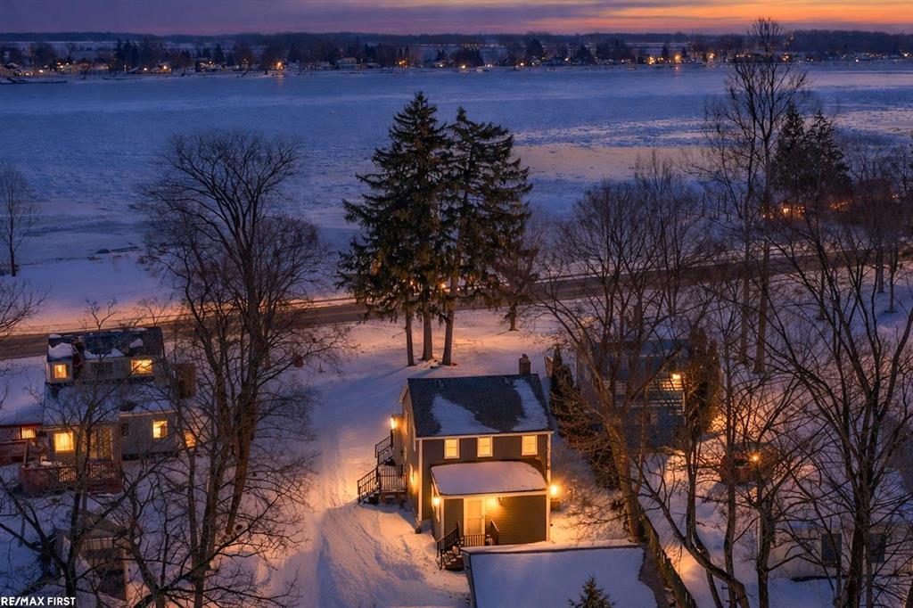 Experience serene waterfront living in this updated 4 bedroom home along the stunning St. Clair River. Step inside to an open-concept kitchen featuring stainless steel appliances, barstool seating, and a seamless flow into the bright and airy great room. Large windows fill the space with natural light and showcase captivating river views, creating a warm and inviting atmosphere. A spacious first floor bedroom and convenient laundry add practicality, while upstairs you'll find three additional bedrooms and a full bath. The attached two-car garage offers plenty of storage space. Relax on the porch and take in Michigan's finest sunrises and sunsets, or enjoy endless water activities such as fishing, boating, and peaceful walks along nearby paths and parks. Cottrellville Township Shoreline Park is just across the street, providing direct access to the river. Recent updates since 2023 include new siding, gutters, driveway, Trex-style deck, high-efficiency 90+ furnace, and more-making this home move-in ready and worry free. Conveniently located near restaurants, shops, and recreational spots, this riverfront gem perfectly blends comfort, style, and location. *Furniture included, making for a great starter home/cottage or Airbnb/VRBO opportunity!*