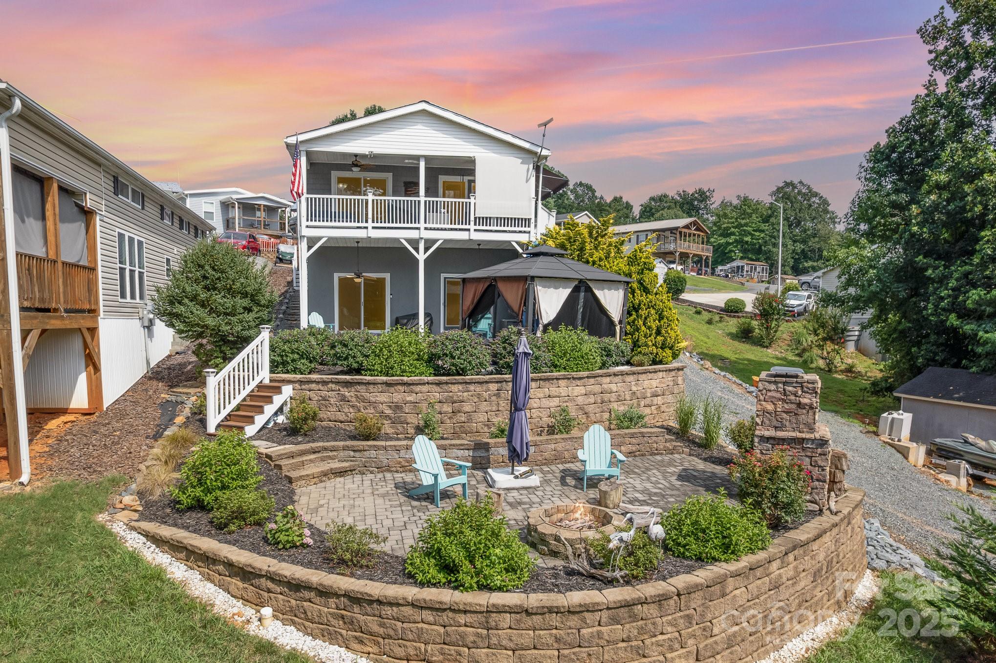 Beautiful 3BR/2.5BA modular home with fully finished walkout basement and gorgeous views of Badin Lake. The main level features a spacious primary suite with a fully remodeled bath, including soaking tub and separate shower, plus a half bath, open kitchen, dining, and living area. Downstairs offers two bedrooms (one without a window), a full bath, and a large den perfect for entertaining family and friends. Numerous updates include LVP flooring (2023), LED lighting, window coverings, LG refrigerator (2022), LG stove and microwave (2025), washer/dryer (2024), 80-gallon water heater (2023), and several new windows (2023). Step outside to a two-tier patio with lake views—the upper level is ideal for relaxing in the hot tub under the gazebo, while the lower patio features a cozy outdoor fireplace. Enjoy the beautifully landscaped outdoor living space, perfect for entertaining or simply taking in the natural beauty of the lake.