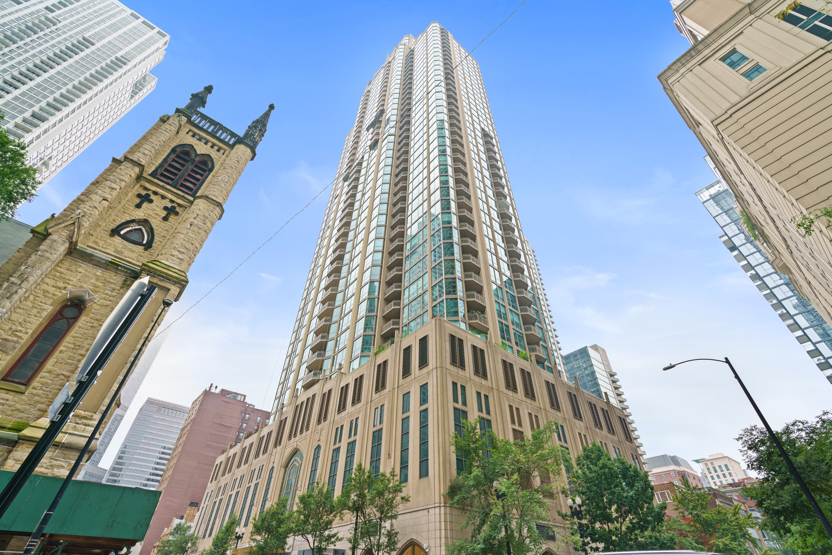 Step into a residence where sophisticated design and sweeping city views come together in one of River North's premier buildings. This rarely available, south-facing corner home at The Pinnacle offers two bedrooms plus a den, two-and-a-half baths, an expansive private balcony and a thoughtfully designed floor plan.    The renovated kitchen is appointed with custom cabinetry, quartz countertops, a farmhouse sink and high-end appliances. The open living and dining areas are enhanced by hardwood floors, elegant millwork and a ventless fireplace, while the adjoining den provides the perfect space for a home office, media room or additional sitting area. Designer wallpaper brings warmth, texture and character to the residence, while striking light fixtures throughout serve as sculptural focal points and elevate every room.    The spacious primary suite offers generous closet space and a beautifully appointed en-suite bath featuring dual vanities and an oversized glass-enclosed shower. Thoughtfully selected finishes throughout complete this distinctive home.    The Pinnacle is a premier full-service building offering 24-hour door staff and concierge services, an indoor pool and spa, fitness center, sauna, private theater, outdoor terrace, receiving services, on-site dry cleaning and a private dog run. Ideally situated in the heart of River North, just moments from the Magnificent Mile, world-class dining, shopping and everything downtown Chicago has to offer. One garage parking space is included.