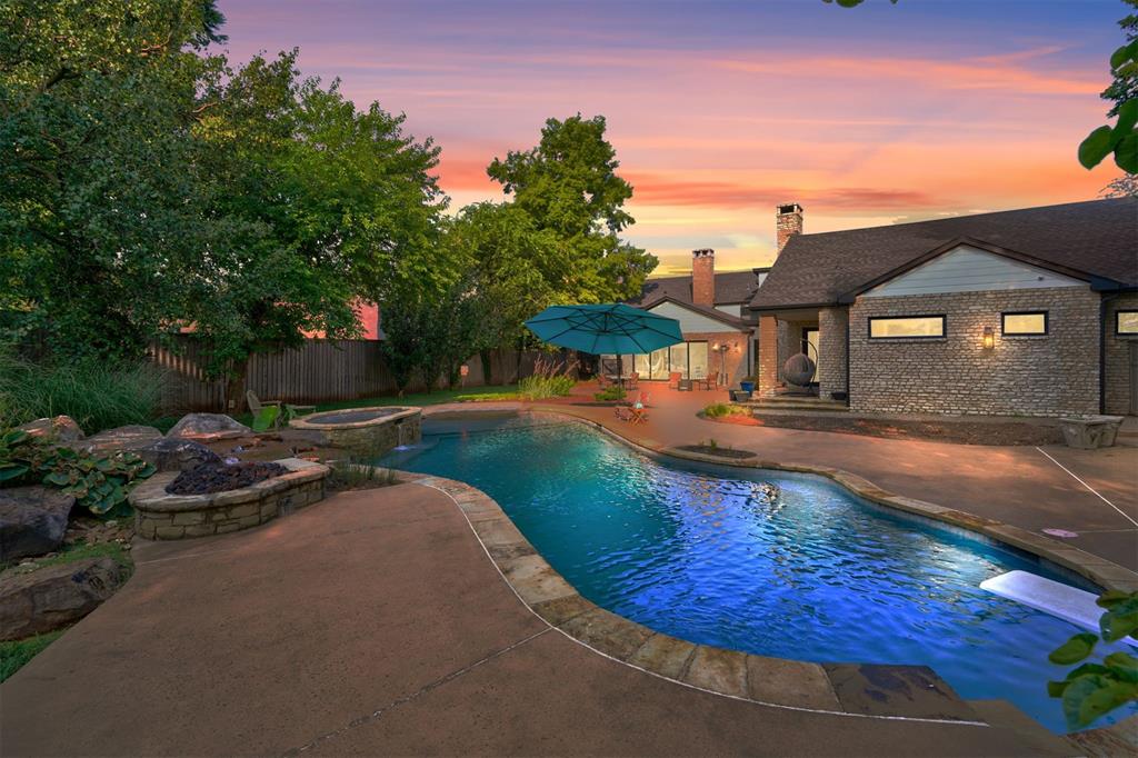 1000% NEW WITH UPGRADES! ITS A MUST SEE- Oversized lot w/FANTASTIC BACK YARD. Moments from Grand Park, this 6,524 sq. ft. Nichols Hills estate seamlessly blends sophisticated design with functional luxury. Welcome to 7100 Waverly Ave meticulously re-designed by Foster Construction. Taken down to the studs and thoughtfully re-imagined, the ALLNEW home boasts a flowing, open layout perfect for contemporary living. From the moment you arrive, custom Bevolo gas lanterns and a striking floor-to-ceiling marble pass-through fireplace set the tone for the elegance within. An entertainer’s kitchen showcases a 10-foot waterfall island, a premier TRUE KITCHEN AND BAR and an ELITE THERMADOR APPLIANCE PACKAGE, Ensuring both beauty and performance. The EXPANSIVE PRIMARY suite is a private retreat, featuring a cozy fireplace, spa-like bath & walk-in shower. The multi-functional closet with a 10-foot island and built-in cabinetry is perfect for curating your luxury wardrobe. The suite connects to a LOWER LEVEL GYM with outdoor access and a versatile theater/game room, plumbed for easy conversion into an additional bath, closet, or office. A CLIMATE-CONTROLLED WORKSHOP offers a unique space for creative or functional use. Bathrooms showcase full marble finishes & state-of-the-art Toto toilets, elevating the experience of daily luxury. Step out to a private, resort-style oasis, fully enclosed by HIGH-fencing and mature trees. The oversized patio, firepit, WALK-IN DIVING POOL, hot tub, and cascading waterfall create the ultimate setting for relaxation and entertaining. A NEW-ONSITE-WATER-WELL WAS DRILLED & supports sprinkler sys, pool, and outdoor faucets. Inside the FULL EWS WATER PURIFICATION SYSTEM ensures pristine drinking water throughout the home. ALL-NEW PELLA WINDOWS AND DOORS bathe the interior in natural light. This home offers an unparalleled blend of PRIVACY, LUXURY & MODERN LIVING on one of Nichols Hills’ most sought-after avenues! This exceptional estate is a MUST SEE!