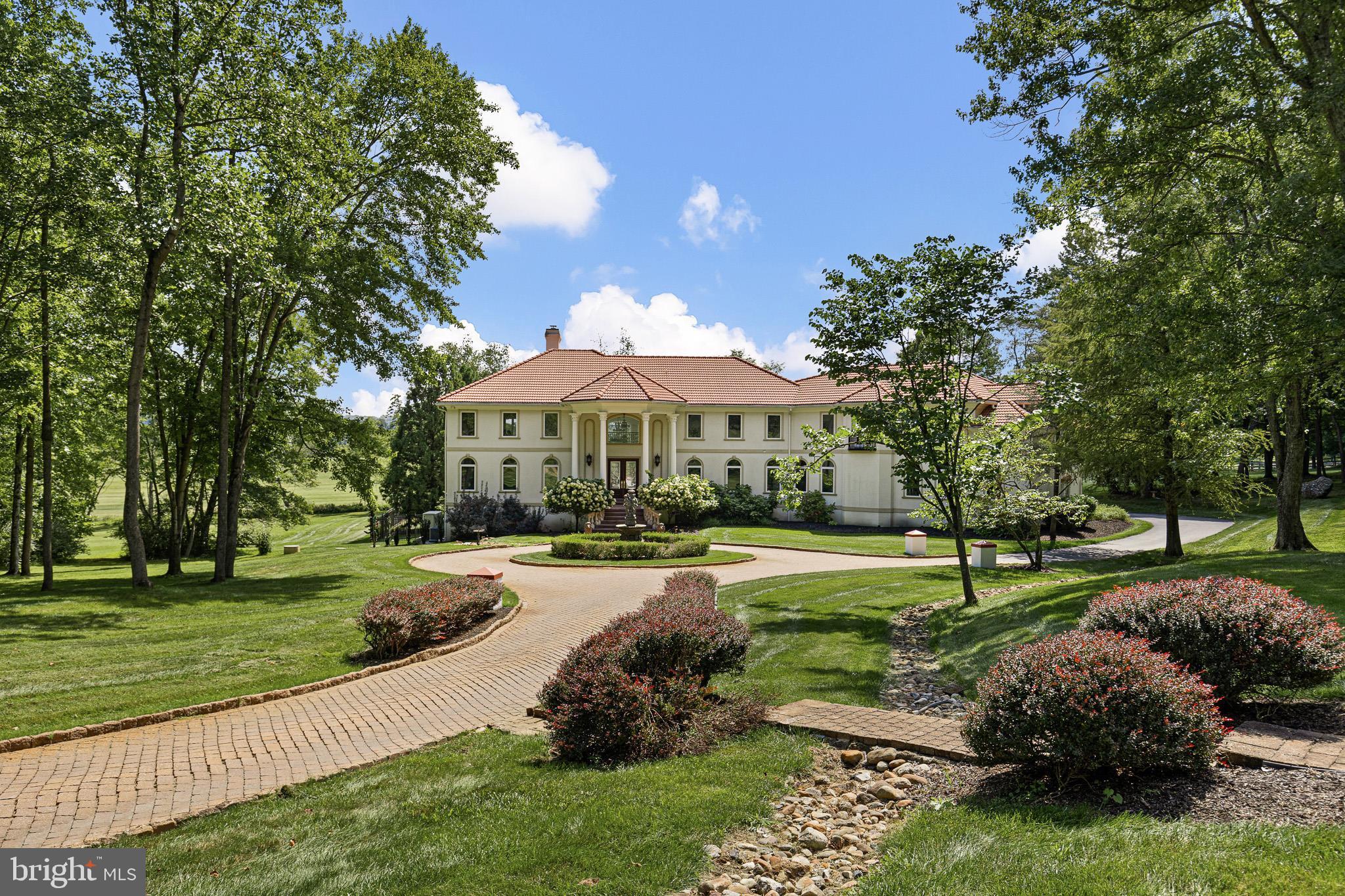 Welcome to Peace by Piece Farm, an extraordinary opportunity to own and make the most of a 44+ acre "Equestrian Facility" nestled in the heart of Chester Springs. Situated in a private and tranquil locale, this farm has served various purposes over the years, from a country retreat to a horse-training facility. A scenic drive past the barns and indoor arena leads to a circular drive and a European-inspired, Custom-Built 5-bedroom home offering breathtaking views of the serene countryside and woodlands. Upon entering through a pavilion-style doorway, you step into the main level featuring a front-to-back 2-story entrance foyer leading to the great room. The great room is adorned with a fireplace, a sizable built-in fish tank, and a wall of windows providing vistas of the terrace, pool, and countryside. Flowing seamlessly from the great room is the grand gourmet kitchen, equipped with a center island, a breakfast area with captivating views, a sunroom, wet bar, and a butler's pantry. This home boasts granite countertops, stone tile flooring, marble floors, crystal chandeliers, and exquisite woodworking with crown molding and built ins. The formal dining room, accessible from the butler's pantry, enhances the ease of entertaining. On the left of the entrance foyer, a study/office and a conservatory room with abundant natural light complete the main level, along with a powder room, closets, and a hallway leading to the 4-car garage. The upper level houses a luxurious primary bedroom suite with a spacious primary bath and walk-in closets. A walkway with expansive countryside views separates the three additional bedrooms, each ensuite with walk-in closets. An extra bonus room serves as a fantastic space for an additional family room and office. The lower level is designed for entertainment and family enjoyment, featuring a large bar area, an exercise room, a bedroom, and a rec room with French doors leading to the lower terrace and heated saltwater pool. This "State of the Art" home comes equipped with a generator, radiant heat floors and a central vacuum. For the equine enthusiast, the property offers a 100 x 200 indoor arena with an observation room, two offices, and a utility room, a 12-stall main barn, a 5-stall lower barn, both with heated wash stalls and tack rooms, a 4-stall shed row, equipment/shavings shed, nine paddocks, and a round pen. 1800 Art School Road is in Act 319 and has 3 separate tax parcels. This spectacular oasis is situated in a coveted and convenient location, providing easy access to major commuting routes and just minutes away from shopping, restaurants, parks, Ludwig’s Corner Horse Show grounds and more!