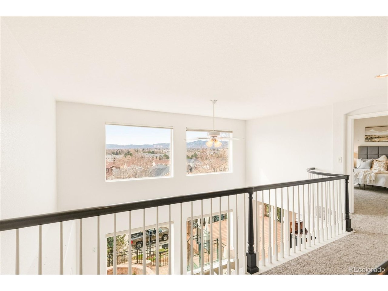 Welcome to 6144 W. Gould Drive... nearly 4,000 finished square feet of beautifully upgraded living. With five spacious bedrooms and four updated bathrooms, this home showcases a new roof, fresh paint, new light fixtures, newer water heater, real hardwoods, new carpet, many new windows, solar panels and vaulted ceilings against the backdrop of unobstructed mountain and golf course views. The primary suite, tucked in its own private wing of the home, offers a serene retreat with a huge closet and a 5-piece bath, perfected with more gorgeous views. The living and dining rooms seamlessly flow into each other and offer formal or casual living spaces. The functional, beautiful kitchen opens to a cozy den with one of two gas fireplaces next to a bonus room that can serve as a playroom, an office, or anything you'd like. Just outside of the den is a Trex deck, perfect for indoor/outdoor entertaining. The lower decorative hardscaped patio is another mini paradise, complete with the same breathtaking view, a xeriscaped yard, sail cloth privacy panels, hanging lights, a hot tub and firepit. The fully finished garden level basement features another gas fireplace, a kitchenette, a theatre, more bonus space, a massive storage area and a conforming bedroom. The deep three-car garage and abundant storage completes this perfect residence. And, as if that weren't enough, residents get to enjoy access to the community pool, clubhouse, tennis courts, pickleball, trails and private lake. The Grant Ranch Village Center provides a lifestyle for those who enjoy outdoor activities - fishing, paddle boarding, kayaking, sailing and more... all included in the low HOA fee. For the sought after Colorado lifestyle and proverbial "million dollar view without the million dollar pricetag," look no further than this thoughtfully updated, beloved, well-maintained home.