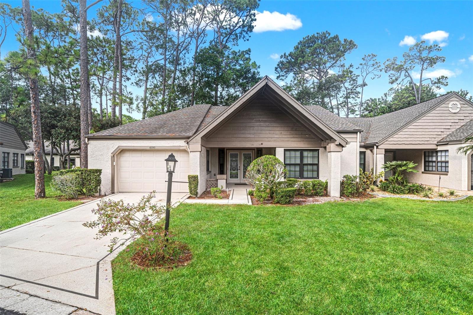 Virtually Staged. AMAZING VILLA in Award-Winning Timber Pines! This beautifully remodeled end-unit duplex villa is located in desirable Manor Place and offers an exceptional combination of style, comfort, and privacy. A welcoming front porch and double-leaded glass door entry lead into a light and inviting interior featuring wood flooring and high-end updates throughout. The spacious living and dining combination showcases an elegant cove ceiling and flows seamlessly into the enclosed lanai, creating a wonderful space for relaxing or entertaining. The beautifully updated kitchen features rich wood cabinetry, quartz countertops, newer appliances, a charming kitchen nook, and an additional pantry with convenient pull-out drawers. A reverse osmosis system is located under the kitchen sink. The primary suite offers a spacious bedroom and an updated bath with tub/shower combination. The generously sized second bedroom has been thoughtfully converted to an office, complete with a Murphy bed, making it an ideal space for guests or a home office. A large walk-in closet provides excellent storage. Situated on a beautiful private lot, this exceptional villa offers both serenity and convenience in one of Timber Pines' desirable locations. Come enjoy the wonderful lifestyle Timber Pines has to offer! HVAC 2010. ROOF 2020. NEWER Windows NEW Hot Water Heater. Enjoy the exceptional lifestyle Timber Pines offers--a gated 55+ active adult community featuring 4 pristine golf courses, an award-winning pickleball center, state-of-the-art fitness & wellness center, clubhouse & restaurant, performing arts center, resident activity center, 2 geothermal pools, tennis, bocce, billiards, wood shop, arts & crafts center, Paws Park, and 100+ clubs & activities. The HOA includes Spectrum high-speed internet, 1 HD box, and 1 cloud-based or HD DVR box. Buyer to pay 3190 Buyer Capital Contribution to TPCA at closing. CALL TODAY!