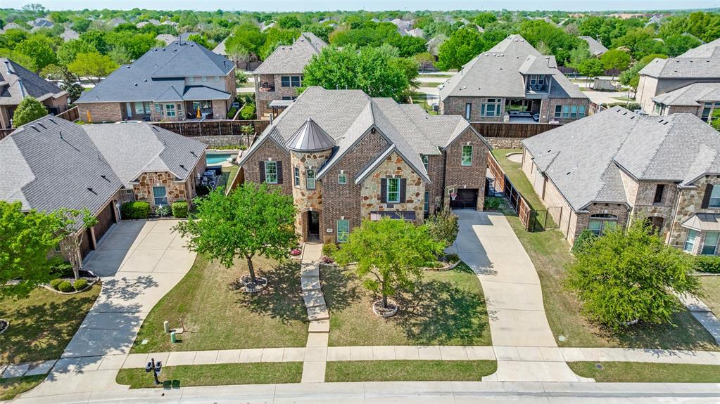 This exceptional original-owner home blends luxury, comfort, and functionality across 5 bedrooms, 5.5 bathrooms, multiple living and dining areas, a dedicated office, game room, media room, and a 3-car garage—all centered around a beautiful pool and spa.The grand entry showcases rich hardwood floors and cathedral ceilings that flood the home with natural light. A private office with French doors sits at the front of the home. The open-concept living and dining areas flow seamlessly into the well-appointed kitchen featuring stainless steel appliances, gas cooktop, double ovens, granite countertops, and a beautiful tile backsplash. The breakfast nook overlooks the backyard oasis and opens to the family room.The downstairs primary suite offers a newly renovated spa-inspired bathroom with a striking light fixture, soaking tub, oversized shower, upgraded cabinetry, and dual walk-in closets. A second downstairs bedroom with an ensuite bath provides ideal guest accommodations.Upstairs includes a spacious game room, media room, three bedrooms, 3 full baths, and a versatile study area. Additional highlights include an oversized walk-in attic for exceptional storage.The outdoor living space is designed for year-round enjoyment with a covered patio, remote-control sunscreens, gas grill, pellet smoker, and a cozy fireplace. The outdoor kitchen area sits just steps from the sparkling pool and spa. Conveniently located near schools, parks & golf, this home is the perfect blend of elegance and everyday comfort.