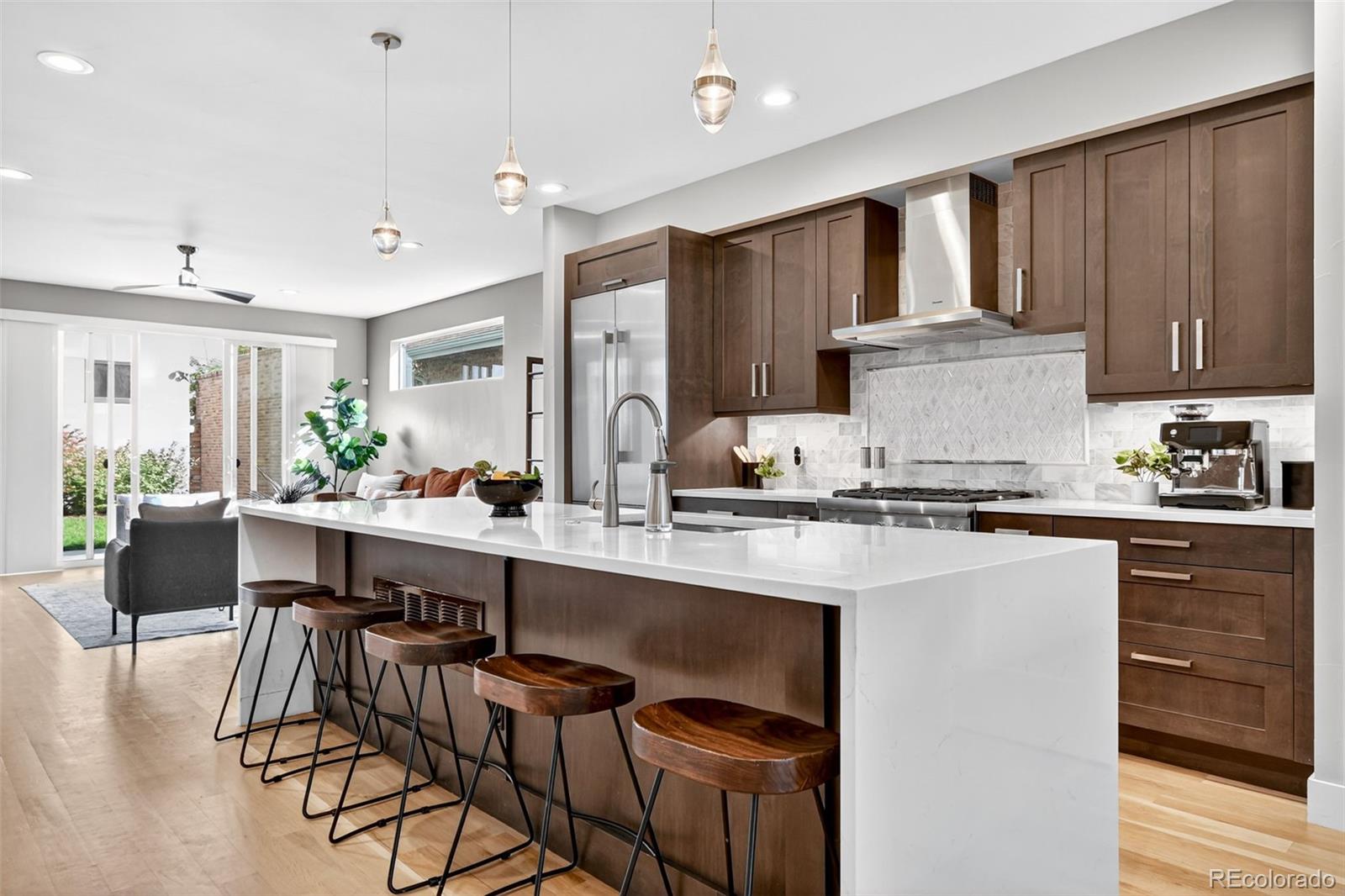 Located just one block from Washington Park, this modern 2018 urban contemporary duplex blendsarchitectural sophistication with effortless livability. Offering 3,502 square feet, 5 bedrooms, and 4.5 baths, it’s a rareopportunity to own a home that balances style, function, and an unbeatable location. Inside, clean lines and natural lightdefine the open floor plan. The chef’s kitchen is both refined and functional, featuring quartz countertops, sleek stainless-steel appliances, and refined custom cabinetry. The dining room is perfect for hosting large dinner parties, while thesliding doors off the living room open to the backyard patio - creating a seamless flow for casual hangouts and al frescodining. The primary suite includes a spa-inspired bath, generous walk-in closet, and a private covered deck perfect forquiet mornings with a warm cup of coffee. On the third floor, an expansive entertainment lounge with wet bar opens to arooftop deck where city lights and mountain views provide an unforgettable backdrop. This level also features a bedroomwith its own bath—an ideal setting for a private guest suite, studio, or inspiring work-from-home space. The finishedbasement, with another versatile guest bedroom, soaring ceilings, and an additional bar, offers even more room to host,relax, or unwind. Every detail has been carefully considered, from designer finishes to the striking exterior of brick andpatina copper. Outside, low-maintenance landscaping, a spacious patio, and an oversized garage with ample storageensure convenience matches beauty. With Wash Park at your doorstep and Denver’s best dining, shopping, and culturejust minutes away, this residence offers the ideal blend of neighborhood charm and urban access. Schedule your privatetour today and experience how this home elevates Denver living.Confidential Inform