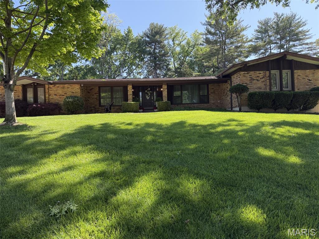Welcome to LADUE TRAILS, one of the MOST SOUGHT AFTER NEIGHBORHOODS in Chesterfield!Spacious, inviting, and designed for connection, this 1970's brick ranch offers approximately 3,800 square feet, four bedrooms, and three full bathrooms—along with the flexible spaces and outdoor amenities that make everyday living and entertaining feel effortless.The main level welcomes you with three bedrooms, new flooring, and a beautifully appointed kitchen featuring custom cabinetry, marble countertops, and a stylish backsplash. Gather around the new gas fireplace in the comfortable living area, or extend the conversation into the large sunroom, where expansive views of the pool, patio, and park-like backyard create a natural backdrop for entertaining. Electrical service is already in place for a future hot tub, adding even more potential for outdoor relaxation.The expansive lower level is ideal for multigenerational living, extended guests, or a private retreat. It includes a spacious bedroom suite with an egress window, a full bathroom, a bar area, and a partial kitchen with the potential to be converted into a full kitchen. Additional washer and dryer hookups, generous storage, and extra closet space provide the flexibility and independence today’s households appreciate.Outdoor enjoyment comes naturally here, with a beautiful pool, inviting patio, and expansive backyard offering plenty of room for summer gatherings, play, and quiet evenings under the stars. The rear-facing, two-car garage is insulated and finished with drywall and includes storage shelving, washer and dryer hookups, and a freezer that stays. Ample parking makes hosting family and friends convenient.Additional highlights include a whole-house water softener, a roof approximately three years old, newer HVAC, and large televisions in nearly every room that remain with the home. Accessibility features, including safety grab bars, add comfort and convenience.With generous living spaces, a flexible lower level, and a backyard made for gathering, this well-appointed ranch offers room for everyone to live comfortably, entertain often, and enjoy every season together.