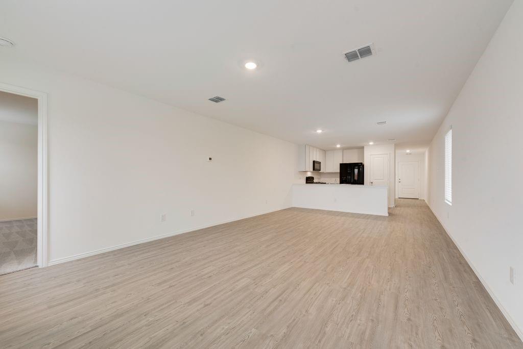 This single-level home showcases a spacious open floorplan shared between the kitchen, dining area and family room for easy entertaining during gatherings. An owner’s suite enjoys a private location in a rear corner of the home, complemented by an en-suite bathroom and walk-in closet. There are two secondary bedrooms along the side of the home, which are comfortable spaces for household members and overnight guests.          
.