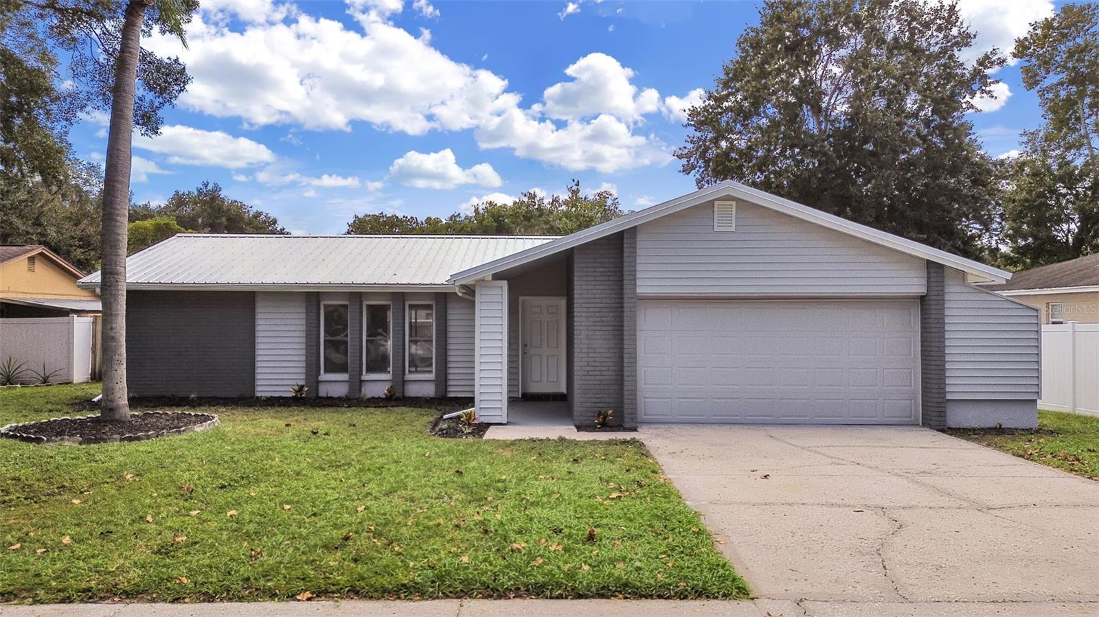 TEAR UP THE HONEY-DO LIST! LUTZ BLOCK HOME: NEW METAL ROOF + NEW HVAC. TEAR UP THE HONEY-DO LIST!! Every major system has been replaced, so all that's left is to move in. This pristine 3-bedroom, 2-bath, 2-car garage concrete block home sits on a 0.19-acre lot in Lutz's established Livingston neighborhood, with NO HOA and NO CDD. TOTAL PEACE OF MIND: NEW Metal Roof (2026), NEW HVAC (2026), NEW Water Heater, and fresh paint inside and out (2026). The kitchen was recently remodeled (2025) with granite counters and new appliances, both baths are fully renovated, and the flooring has been replaced within the last two years. Light the fireplace on a cool evening or take your coffee out to the screened back porch. THE LIFESTYLE: You are about three-quarters of a mile from Maniscalco K-8 School and about three miles from Liberty Middle and Freedom High. Publix and a Walmart Supercenter are each about two miles away. AdventHealth Tampa and St. Joseph's Hospital-North are within five miles, USF is close by, and I-275 at Bearss Avenue is about two and a half miles from your driveway, with I-75 just beyond. Lake Park and the Lutz Public Library are a short drive. FEMA Flood Zone X. Skip the repairs and start enjoying your new home. Schedule your private tour today!