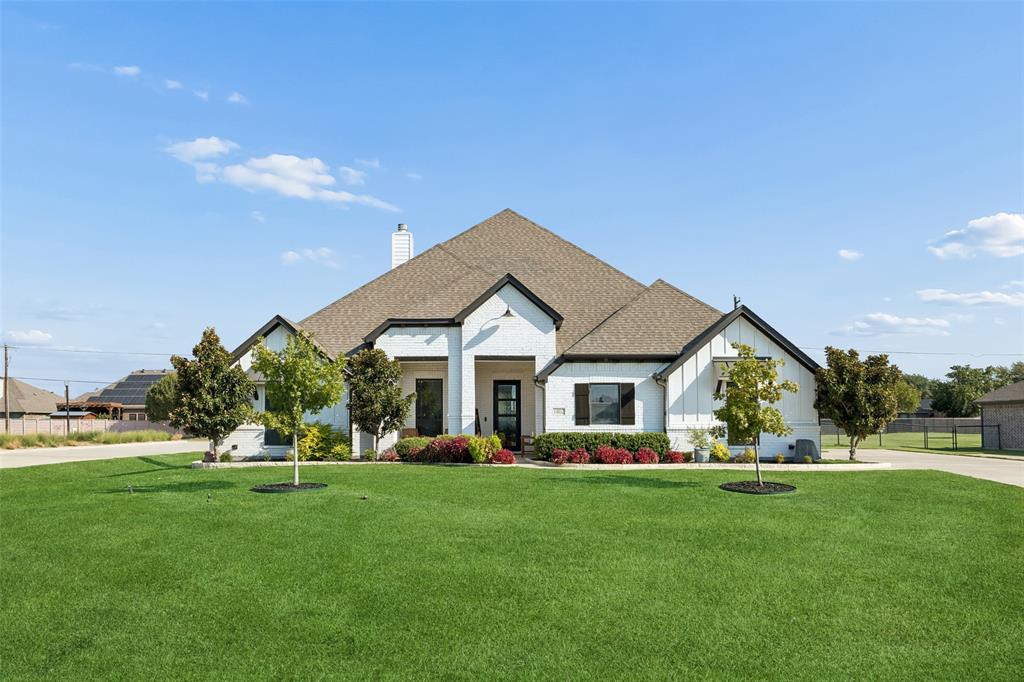 Modern Farmhouse Living on a Half-Acre in Legacy RanchWelcome to 1402 Oliver Creek Lane, where a painted brick modern farmhouse rises on a half-acre in Legacy Ranch, Justin. Completed in 2020 by Brookson Builders, this 3,116-square-foot retreat pairs bronze windows and metal awnings with an outdoor kitchen and fireplace, a three-car garage, and Northwest ISD schools. Country space, polished style, and effortless entertaining await you at every turn.Step inside and the story unfolds on wood-look tile that flows from the entry through the study, living room, kitchen, and nook. The living room glows with pop-up ceiling treatments, decorative lighting, and a fireplace made for cool Texas evenings. The kitchen is the heart of the home: custom cabinetry, granite countertops, a generous island, gas cooktop, built-in appliances, and a walk-in pantry, with a shiplap-accented breakfast nook for slow mornings. A barn-door study can double as a fourth bedroom or office, while the game room and media room keep everyone entertained. The primary suite is a true retreat, with a freestanding tub, separate shower, dual vanities, granite counters, walk-in closet, and barn-door details. Two additional bedrooms and a half bath complete the plan. Outside, the covered patio hosts dinners around the outdoor kitchen and fireplace, then the fire pit takes over as the stars appear. A sprinkler system, iron fence, and three-car side-entry garage make life easy, while the tankless water heater, six-year-old roof, and dual Trane systems add peace of mind. Offering the perfect balance of peaceful country living and everyday convenience, this half acre retreat feels worlds away while keeping shopping, dining, schools and daily essentials within easy reach.  Come home to a little more space, a little more quiet and your own slice of heaven.
