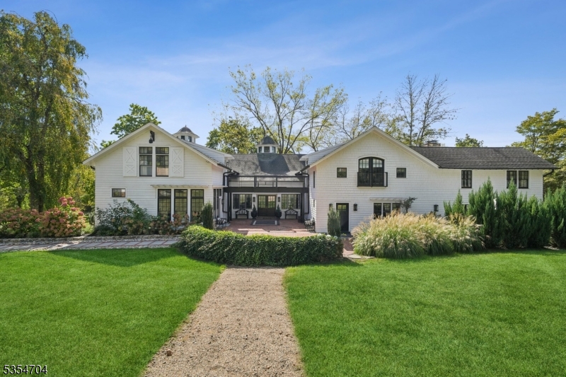 Nestled on a prestigious mountain top awaits a world of unparalleled luxury & timeless elegance in this one-of-a-kind 1870 farmhouse, masterfully restored & expanded to offer over 8,000 square feet of opulent living space. Set on more than 6 breathtaking acres, this remarkable estate offers a rare combination of historic charm and modern luxury, creating a truly extraordinary living experience. From the moment you arrive, you'll be captivated by the estate's grandeur, with a welcoming facade that exudes character & sophistication. Step inside to discover grand, light-filled rooms, each designed to blend old-world elegance with modern comforts. This home provides an abundance of space. Architectural details abound throughout the property, including a breezeway that elegantly connects the two wings of the home. The estate also includes a detached 4 car garage, while a separate recreational space adds versatility to the property.  A hidden gem awaits - a bonus lounge offering an intimate & private retreat. For the fitness enthusiasts, a workout room can also be found in the additional outdoor structure. For those seeking customization, the detached indoor pool house offers endless potential for finishing to suit your personal style, whether transforming it into a luxury spa, indoor/outdoor pool or entertainment space. This is truly a must see!