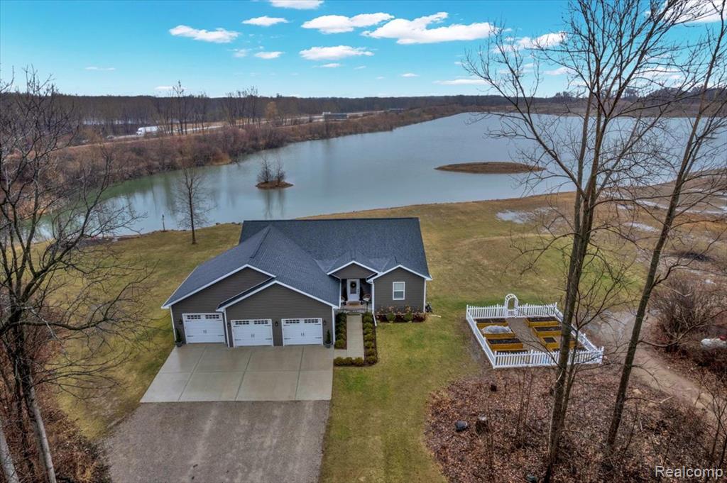 Tucked away among towering trees, this picturesque retreat offers the perfect blend of privacy and natural beauty. A winding drive leads you to a serene setting on over 11 acres, complete with private beachfront on an all-sports lake. The property is in pristine condition and features scenic trails winding through the woods, a rock-lined sandy beach, and a beautiful deck ideal for entertaining or simply enjoying the peaceful surroundings. Inside, the open floor plan offers spacious rooms filled with natural light. The home features first-floor laundry, stainless steel appliances, and a large pantry for added convenience. The exquisite primary suite provides a true retreat with a spa-like bath featuring a walk-in shower and freestanding tub. The finished basement expands your living space with a custom bar and plumbing already in place for a third bathroom perfect for hosting guests or creating the ultimate recreation area. This rare property combines luxury, privacy, and lakefront living in a truly breathtaking setting.