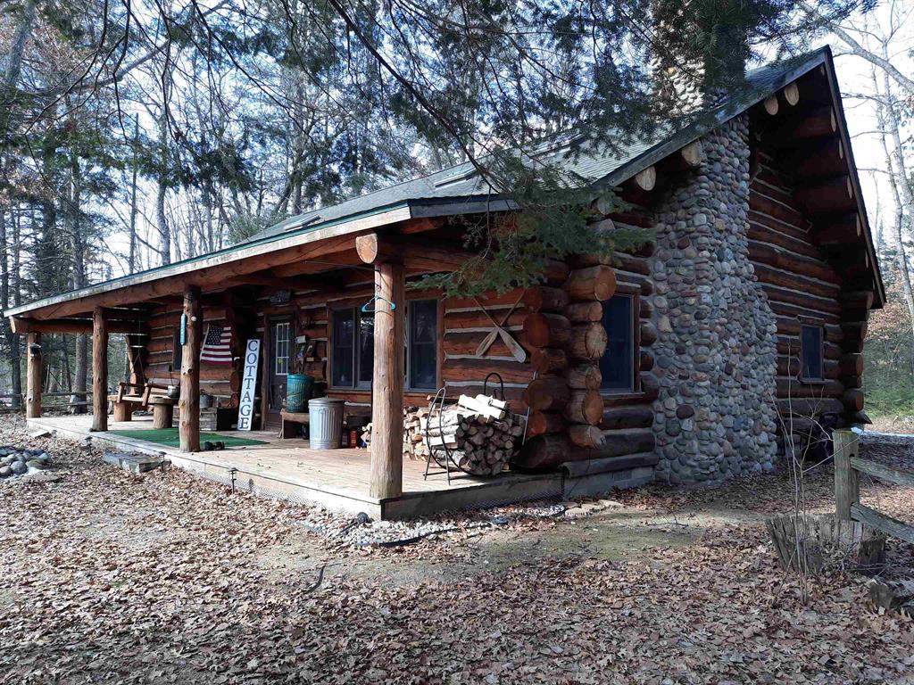 Here is the beautiful 1,670 sq ft log home and 40 acres you have been dreaming of! Complete with private pond...all surrounded by state land on 3 sides! This log home has all the amenities and is spaciously laid out with cathedral ceilings and a great loft area!  Just in time for summers fun, you will love your own completely secluded recreational property. You will be amazed that you can own this very private estate and still be within a short drive to Houghton Lake, Saint Helen, West Branch and I-75. This opportunity is ready for you to use year around or for those great private family vacation getaways. This property has all the wildlife viewing and sporting opportunities ready for you. There is a combination of high ground hardwoods and alder marshes that the deer, turkey, grouse, bear etc love to call home. You will appreciate the recent updates: new furnace (2025), beautiful kidney shaped pond complete with aerator sprinklers for winter oxygen for the fish, new flooring (2022), and the rear deck and electrical service has been added for the hot tub. Your toys will appreciate the 24 x 40 pole building garage and work shop area and additional storage shed. This property has it all...ready for you to enjoy...the appliances, home furnishings, hot tub, 2 hunting blinds, 2 ladder stands and a 12 month home warranty are all being made available to you from the sellers.  Don't miss out on this truly remarkable opportunity.