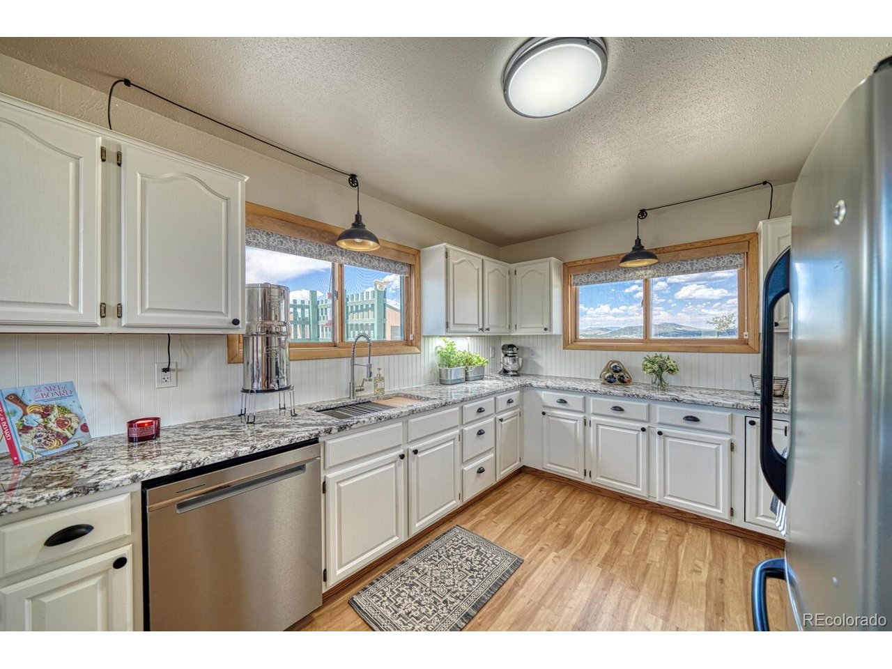 Indulge in the pinnacle of Colorado mountain living with this exquisite 3-bedroom, 3.5-bath chalet-style home, gracefully situated on 38 acres of wilderness with front-row views of the iconic Sangre de Cristo Mountains. This striking home combines classic mountain architecture with thoughtful modern upgrades, creating a timeless retreat that soothes the soul and inspires the senses. From the moment you enter, you're greeted by soaring vaulted tongue-and-groove ceilings and floor-to-ceiling windows that flood the interior with natural light and frame breathtaking views. The great room exudes warmth and sophistication with rich hardwood floors and a charming wood stove, creating the perfect ambiance for cozy evenings and elegant entertaining alike. The expansive kitchen is a culinary dream, offering generous counter space, quality cabinetry, and room for hosting unforgettable gatherings with family and friends. On the lower level, the walk-out basement offers a spacious bedroom and full bath, along with an oversized laundry and utility room-ideal for long-term guests or simply managing the day-to-day with ease. Step outside and discover the crown jewel of this property: a fully remodeled, beautifully appointed yurt. This isn't your average glamping tent-this yurt is a refined living space complete with a spacious great room, full kitchen, bath, and a skylight that invites the stars inside. Whether used as a guest house, family space, creative studio, or private sanctuary, the yurt adds remarkable value, versatility, and charm. The property also includes a detached 2-car garage, a greenhouse for year-round gardening, and endless open land to roam, relax, or explore. With solar power in place, you'll enjoy a more self-sufficient lifestyle. This home isn't just a place-it's a feeling. A rare blend of luxury, freedom, and mountain magic. Schedule your private showing today and step into the peaceful, elevated lifestyle you've been dreaming of.
