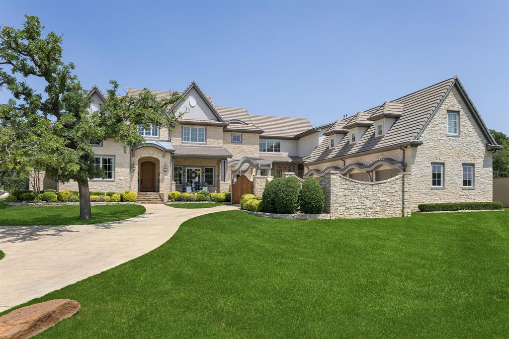 Welcome Home to this exceptional estate in the gated community of Cielo. Set pristinely on a private, wooded 1-acre lot, this impressive home was designed & built by Betty Baker of Veranda Homes as the 2016 Fort Worth Magazine Home Of Dreams. Enter the Grand Foyer, where a striking elliptical staircase & soaring ceilings set the tone for the home’s refined European-inspired aesthetic. An Expansive Great Room unfolds w vaulted ceilings & exposed fir beams, seamlessly connecting the formal Dining, Full Bar, temp controlled Wine Room, Chef's Kitchen + Breakfast banquette. The Chef's Kitchen boasts a double-island design, premium appliances & large Pantry, while a fully Prep Kitchen w double ovens keeps the main Kitchen pristine when entertaining. The Family Room w fireplace enjoys a wall of 11'x18' collapsible glass Fleetwood doors to a covered & screened patio, for effortless indoor-outdoor living. Designed for entertaining, the downstairs Game Room has its own Wet Bar, billiard and media space. Private Executive Study has soaring ceilings, custom built-ins + its own exterior access. The luxurious Primary Retreat offers private courtyard access, a spa bath with a dramatic 2,500-pound charcoal granite soaking tub, Reve Bleu marble finishes, dual vanities & an expansive custom dressing room. A Private Guest Suite with patio access offers flexibility as a cabana or in-law space. Upstairs, all three Bedrooms have lovely private en-suite baths. Upstairs is complete with a dedicated Wellness Room, full Gym plus a large walk-in attic storage. Step outside to a true Backyard Oasis! Stone-lined pathways surround the resort-style, completely renovated pool, putting green and turfed game area. The backyard is complete w a new outdoor living with wood-burning fireplace, multiple covered lounge spaces, patio w retractable screens + a linear fire pit. Savant Smart Home, custom window treatments, Liquid Cooled Generator,  Emtek Crystal door knobs + so much more!