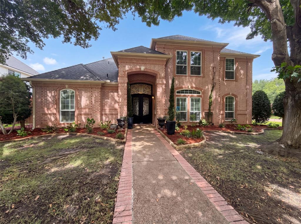 4606 Mill Wood Dr is a two-story Colleyville brick home on a corner lot. A two-story entry with iron doors opens to formal living and dining rooms and a family room centered on a fireplace. The kitchen features quartz countertops, a center island, abundant cabinetry, and stainless steel appliances including a double oven. The primary bedroom connects to an ensuite bathroom with a double-sink vanity, a garden tub, and a separate walk-in shower, while additional bedrooms are served by multiple full bathrooms. Outside, a paver deck surrounds an in-ground pool within a fully fenced backyard, and a three-car garage completes this well-maintained residence with practical amenities throughout every room. This home has been virtually staged to illustrate its potential.. Home comes with a 100-Day Home Warranty and a 7-Day Home Test Drive to move in 7 days early for free