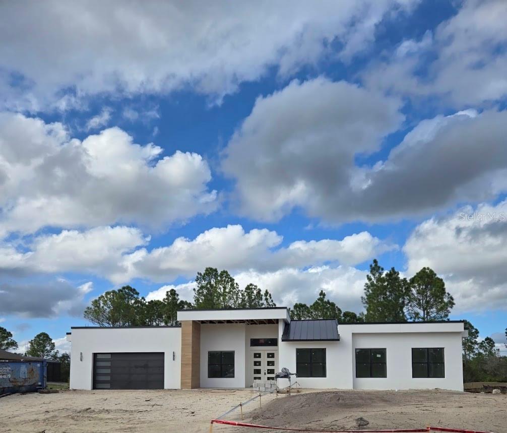 Under Construction. Brand-New Custom Luxury Home | Completion Mid-April. Pictures shown are dated 3/01/26. Pictures will be updated to reflect the construction progress.Currently under construction and scheduled for completion by mid-April, this stunning custom residence offers 2,657 square feet of thoughtfully designed luxury living in one of Central Florida’s most desirable communities. Featuring 4 Bedrooms, 3 Full Bathrooms, and a Private Studio, this home showcases an expansive open-concept floor plan with soaring 12-foot ceilings in the main living areas and 10-foot ceilings in all bedrooms, creating an impressive sense of space and light throughout. The spacious 17’ x 15’ Owner’s Suite serves as a private retreat, complemented by a remarkable 16’ x 7’ grand walk-in closet. Elegant 4’ x 4’ porcelain tile flooring flows seamlessly throughout the entire home, adding modern sophistication and durability. Designed for both everyday comfort and entertaining, the home also features: * An expansive 7’ x 6’ Walk-in Pantry * A 24’ x 22’ Oversized 2-car Garage* A generous 24’ x 11’ covered Back Porch, perfect for outdoor living* Spray Foam Insulation throughout the entire home and garage for superior energy efficiency* Concrete Block Construction for strength and longevityDimensions are approximate. Exact measurements can be seen in the floor plan attached.Ideally located in Wedgefield, with immediate access to State Road 528, this property offers convenient connectivity to Orlando, Orlando International Airport, and the beautiful beaches of Cape Canaveral and Cocoa Beach. This is a truly exceptional opportunity to own a custom-built home in a prime and growing location.