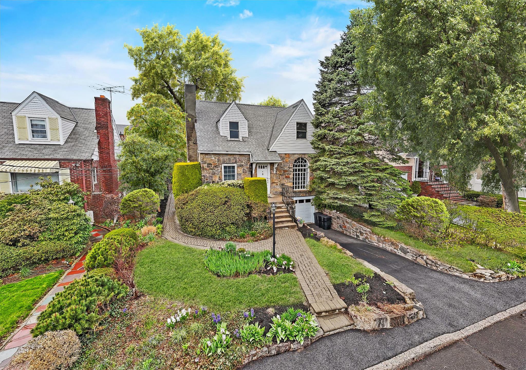 Great opportunity! On the market for the first time in nearly 40 years and virtually staged to give you an idea of how you can utilize the space. This spacious 5-bedroom Tudor Revival style home with its unique Palladian front window offers over 3,000 square feet of total space and is located in one of Yonkers’ most established and desirable neighborhoods of Lincoln Park.

Tucked away at the end of a low traffic, tree-lined dead-end street, the property features mature landscaping with blooming perennials, a fenced backyard with a huge patio, a driveway that can fit 2 cars, plus a 2-car garage—perfect for households needing extra space. The large walk-out basement with egress windows adds even more potential.

Inside, the home is filled with character, and a generous and open floor plan that includes an open living & dining room, seperate den with access to the back yard, eat in kitchen and a first floor bedroom. This home can easily adapt to a range of needs—whether you’re upsizing, working from home, or planning for multi-generational living. All five bedrooms including the one on the main level are true bedrooms with ample space and custom closet systems.

Recent updates include fresh interior paint, new flooring, gleaming hardwood floors, an updated half bath, a new hot water heater, gas heating, a repaved driveway, a new garage door with opener, and replacement windows throughout.

This is a move-in ready home with strong bones and plenty of potential for future personalization. Conveniently located near shopping, restaurants, schools, and parks, with quick access to public transportation and major highways for an easy NYC commute.

Don’t miss the opportunity to make this home your own—schedule your showing today!