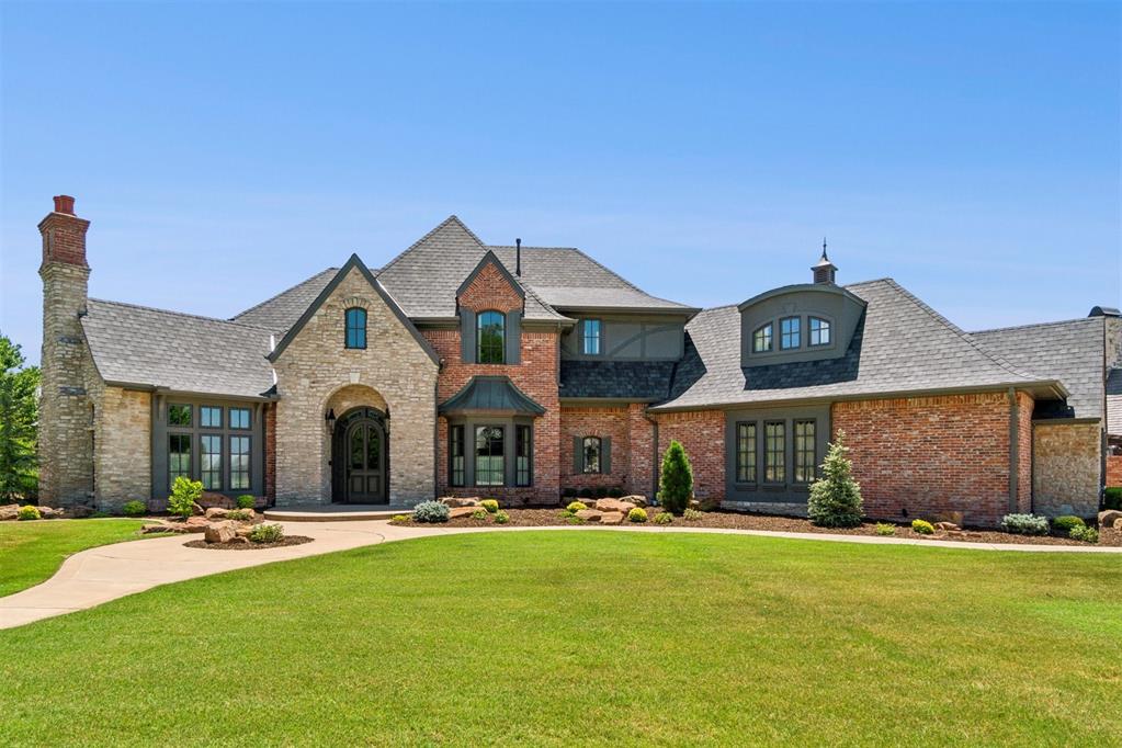 Discover refined living in this beautifully renovated (by an interior designer) and thoughtfully curated home, nestled within the exclusive gated community of Ashton Grove—one of west Norman’s most sought-after neighborhoods. If you viewed this property before, prepare to be amazed by its breathtaking transformation.
From the moment you enter, the grand foyer with soaring ceilings and a striking iron spiral staircase sets the tone for what’s to come. Every detail has been meticulously updated, ensuring a seamless blend of elegance and comfort throughout. The dedicated home office features a custom built-in cabinet with a hidden pull-out printer shelf and built-in outlet, enhanced by fresh paint and a cozy fireplace. Vaulted ceilings and expansive windows add to the airy, light-filled ambiance. Interior upgrades include fresh paint throughout, stunning new lighting fixtures, custom drapery with elegant rods and shades, and thoughtfully selected finishes in every room. The utility/mud room has been upgraded with additional cabinetry for storage, a second dishwasher, and even a Sonic ice maker for added convenience. The kitchen is a true showpiece, completely reimagined with new custom cabinetry, a 48” dual-fuel range, drawer microwave, designer coffee bar, statement vent hood, and a hand-selected stone backsplash that elevates the entire space. Step outside into your own private oasis complete with stunning pool and hot tub with peaceful waterfall feature, built in grill backyard is fully enclosed with masonry fencing for ultimate privacy. The exterior of the home was just recently painted and the landscaping was just updated as well. This home has been impeccably maintained and is ready for you to enjoy elevated living at its finest.
