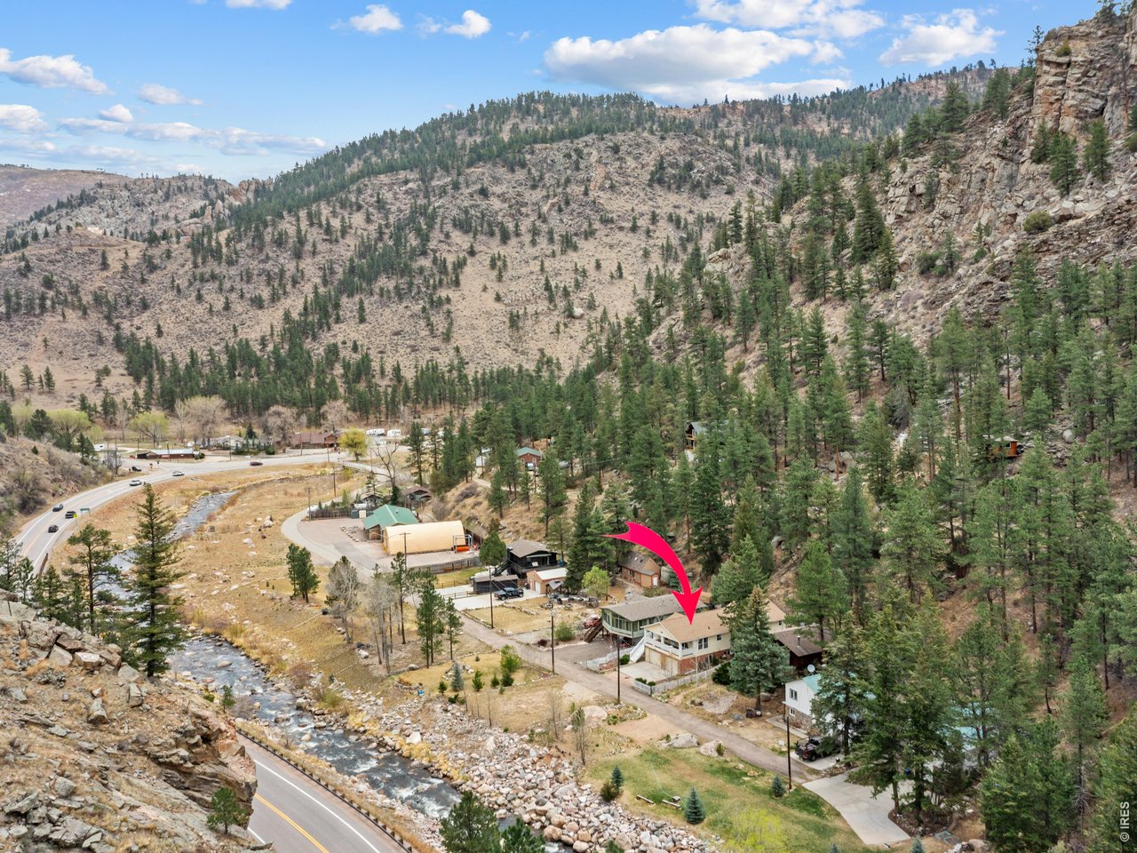 Don't miss this rare opportunity to own a mountain home set right on the Big Thompson River. Fish from your own property or simply relax and enjoy the stunning river and mountain views from the expansive covered front porch. This inviting home offers convenient single-level living positioned above the oversized two-car garage, complete with 13x12 storage room and 13x13 workshop area. The living room features vaulted ceilings and an abundance of windows that fill the space with natural light, creating a bright and airy atmosphere. The kitchen has stainless steel appliances, a gas range and breakfast bar plus separate dining room. The generous primary suite includes a five-piece bath with large soaking tub and walk in shower and spacious walk-in closet. With three bedrooms and two full bathrooms plus laundry room, this property is ideal as a year-round residence or a peaceful second home, all within easy reach of Loveland and Estes Park. Nestled in the mountains along the Big Thompson River, this home invites you to embrace riverfront living-bring your fly rod and kayak and enjoy the serenity, recreation and beauty right outside your door.