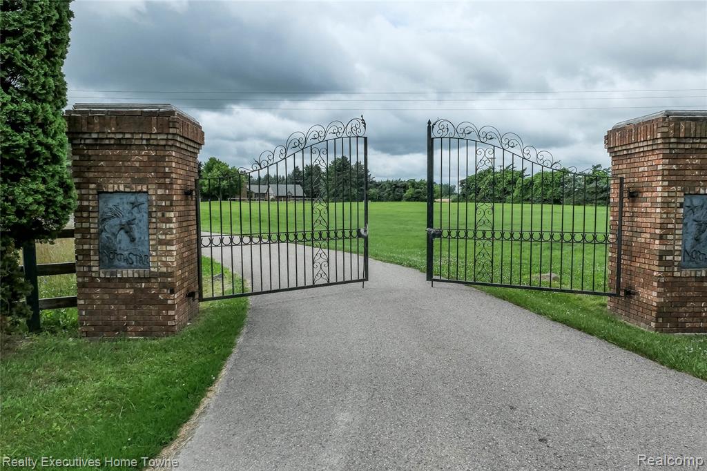 Bring your vision and inspiration to this 24.6 acre hard-to-find equestrian property in a prime location—paved road across from state land, just 45 minutes to Macomb or Metamora, and an easy 60-minute drive to Detroit or Flint. This property has great bones, a dream setting, and room to create a spectacular retreat or working horse farm.  Perfect for investors, horse enthusiasts, or anyone seeking a large parcel with endless privacy and potential. The property includes a sprawling solid 3,400 sq ft brick ranch with 3 bedrooms and 3 full baths. While the home offers a solid structure and generous layout, it is in need of a full renovation. A true fixer-upper with incredible potential for those ready to renovate and restore. The 200’x 60’ Horse Barn with 13 large stalls and indoor riding arena could be a breeding/training facility complete with sand track/show ring and several turn out wood fenced paddocks. Need space for tools and toys? Enjoy this 100'x40' Pole Barn with cement floor, lighting, two heaters, wood stove and office space! Property is being sold AS-IS, and is priced to reflect that. Don’t miss this opportunity—bring your contractor and imagination!