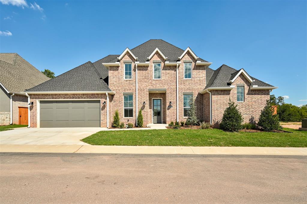 Ideally situated on a serene tree-lined greenbelt, this exquisite zero-maintenance residence boasts an open floor plan that seamlessly blends convenience and sophistication. The exterior of the home features a brick facade with contrasting accents. Inside, you'll experience an expansive open floor plan, enhanced by abundant natural lighting and hardwood floors that flow seamlessly throughout the space. Off the entry, you'll find a study through painted French doors featuring custom built-in cabinetry and wallpaper that set the tone for the masterfully designed features throughout the rest of the home. Enjoy a view of the greenbelt while working in the kitchen or lounging by the gas fireplace adorned with built-in cabinetry. The sliding patio doors lead to the vast covered patio, perfect for indoor and outdoor entertaining. The kitchen is equipped with a stainless steel professional 6-burner gas stovetop oven, pot filler, arched wood-stained cabinetry, and an expansive island with bar seating. Built with quality finishes such as upgraded trim, built-in speakers, designer selections and top-of-the-line Dacor appliances. Just past the dedicated dining space is a spacious bedroom with en-suite bathroom. The primary suite is privately located and features timeless details with a light spa-like color pallet. The primary bath is designed with your comfort in mind, featuring a glass-encased shower, dual vanities with a decorative backsplash, a deep soaking tub, and an expansive walk-in closet. Near the primary suite is the laundry room, a stylish powder bath and generous storage solutions. Upstairs, you'll find a bonus space with built-in cabinetry, a spacious bedroom with a nearby full bathroom, and convenient walk-out attic access. Residents can enjoy a clubhouse and pool as part of the zero-maintenance, gated community. Located in North Edmond, this home offers quick access to I-35 and nearby amenities, including grocery stores, shopping, and entertainment.