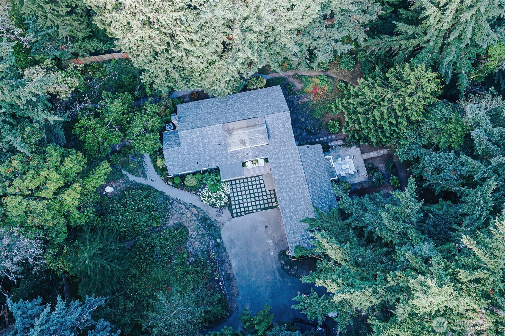 A remarkable home boasting large open living spaces w/timeless character with attention to detail. On a gorgeous 1-arce natural backdrop w/partial view of the Sound. Seller offering rate buy down on this 5 bdrm, 2.5 baths beauty that has been renovated! The main floor has a chef's kitchen, lg dining space w/built-ins, a bdrm & full bath, a wood fireplace for cozy evenings. Refinished hardwood floors span the main floor. The 2nd floor offers 2bdrms & 3/4 bath. The lower level offers a large space w/a projector screen & surround sound plus a kitchenette & 1bdrm & lg office/bdrm perfect for multi-generation living or guests, & extra storage behind the hidden door. New roof, windows & so much more! A hidden gem waiting for you to discover!