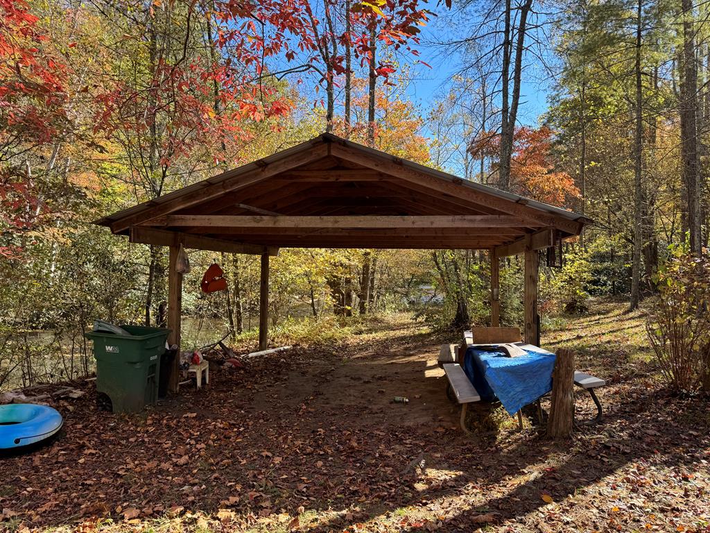 This beautiful 5.21-acre wooded property located in the peaceful countryside of Patrick County, Virginia (TBD Ararat Hwy, Ararat, VA 24053. The land offers a mix of natural beauty and practical improvements, perfect for a private retreat, full-time residence, or weekend getaway. A dirt driveway leads into the property from the state-maintained, paved road frontage, ensuring both accessibility and seclusion.  The land features a (24' x 40') detached metal garage with a concrete floor, ideal for vehicle storage, a workshop, or equipment. The seller began construction on a (28' x 36') home, with the interior roughed in for an open-concept living room, dining room, and kitchen, along with 2 bedrooms, 2 baths, and a laundry area in one of the bathrooms. A septic system for a 2-bedroom home has already been installed, offering a head start for your building plans.  Adding to the property's appeal is 1,500 feet of frontage on the scenic Dan River, providing an opportunity for peaceful views, fishing, and outdoor recreation. If you're looking for a serene, wooded property with water access and a solid start toward your dream home, this 5.21-acre parcel in Ararat, VA, is a must-see. 20 minutes to Mt. Airy, NC.  This property is sold as land with structures on it.  SOLD AS IS!