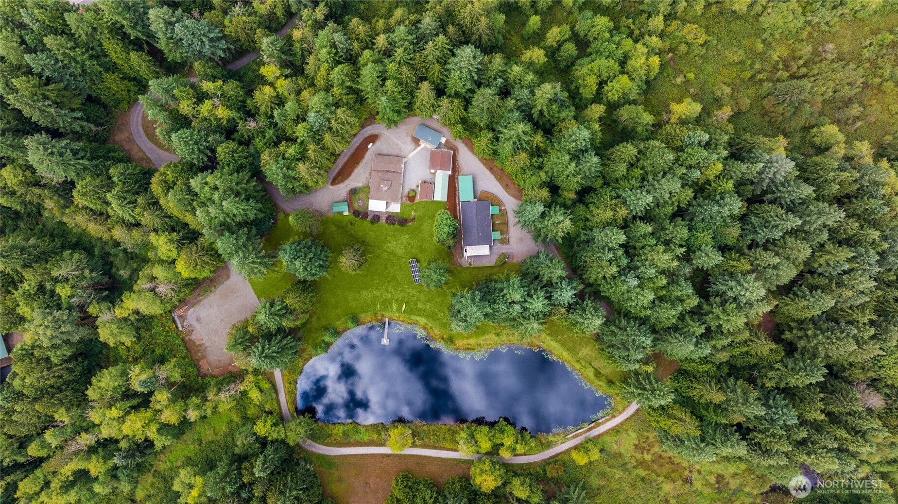 Discover 14 acres of tranquility w/ your own private lake & endless possibilities! The main home features 3 bedrooms, 2 baths, & a custom live-edge bar perfect for entertaining. Over $200,000 in recent remodels include new roofs, split units, kitchen, baths, flooring, appliances, patios, solar, fencing, & more. A charming Duplex offering two 2-bedroom/1-bath units (1,000 sq. ft. each). A huge shop, multiple dwellings, & space for tiny homes or glamping provide limitless potential. Live in the main house while building your own rental community. Conveniently located near everything! Pre-inspected.