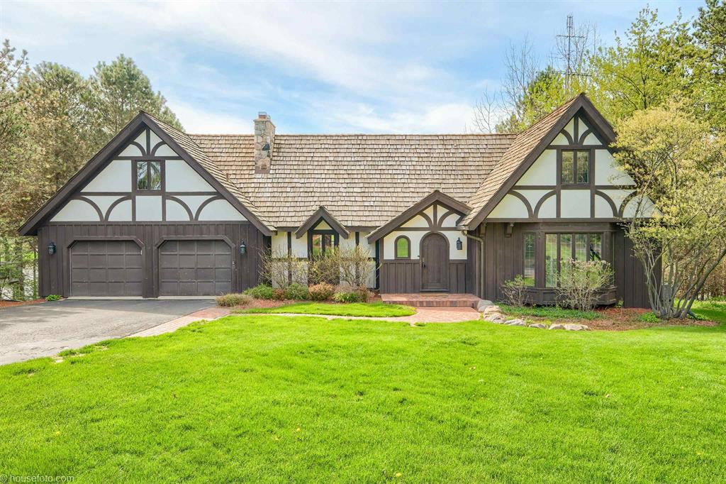 107 FEET OF FRONTAGE ON ALL-SPORTS LAKE LAPEER! This stunning English Tudor was designed by the same architect as the Manoogian Mansion and offers over 4,100 square feet of finished living space. Enjoy breathtaking sunset views from the spacious Trex deck.  The finished lower level is perfect for entertaining, featuring a wine fridge, beer tap, and an impressive 400-bottle temperature-controlled wine cellar. Inside, you'll find beautiful cathedral ceilings and updated hardwood floors throughout.  Recent updates within the last three years include a completely renovated kitchen with custom cabinetry and Thermador appliances, a new gas fireplace, professional landscaping, and stairs leading to your private beach and patio with fire pit. Additional improvements include the Trex deck, stamped concrete lower-level patio, water heater, water softener, and purification system.  Additional lake info go to Lake Lapeer Association; lakelapeer.net