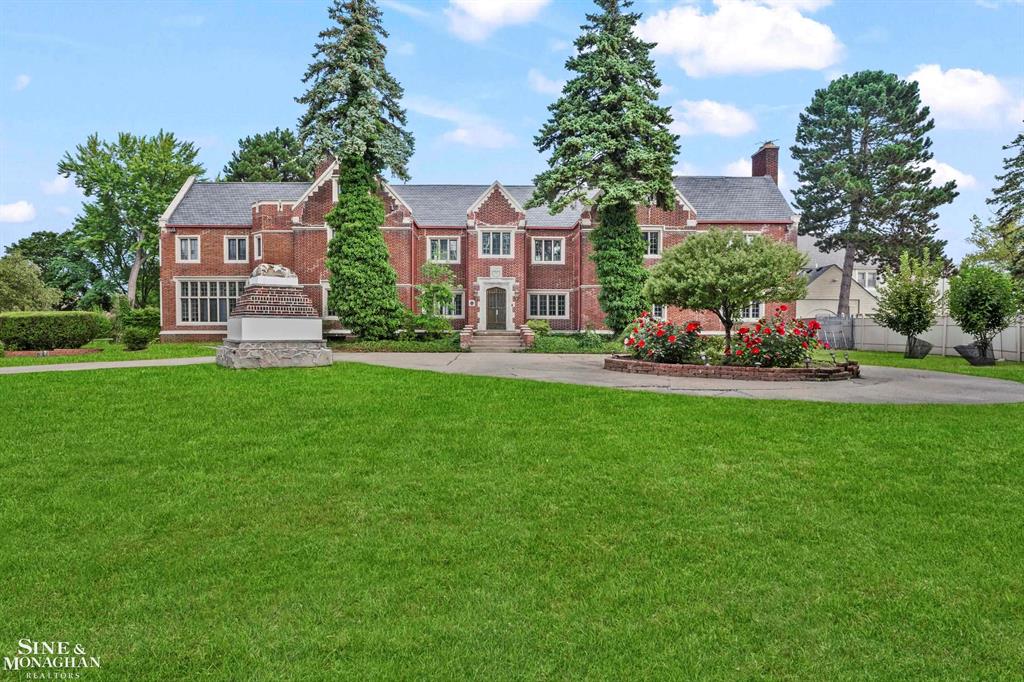 A true Grosse Pointe landmark, this Tudor-Revival estate was designed in 1916 by renowned Detroit architect Louis Kamper. Offering over 10,000 sq ft, 9 bedrooms, and 7.5 baths, the home showcases a grand scale rarely seen in the area. Each bedroom features its own private bath-many with original tile and period details-along with unusually large closets for its era.  Historic craftsmanship shines through the original library woodwork, the solid front door, and the third-level butler's pantry. Hardwood floors run throughout, and the flexible layout includes 3 full kitchens plus a private suite with bedroom, kitchen, and bath-ideal for in-law quarters, a teen retreat, or those seeking spacious elegance with a touch of history.  Perfectly located in the heart of Grosse Pointe, the residence offers walkable access to shops, restaurants, private parks, and the lakefront. More than a home, this is a rare opportunity to own a preserved piece of Detroit's architectural legacy, blending timeless detail with the lifestyle that makes Grosse Pointe so desirable.