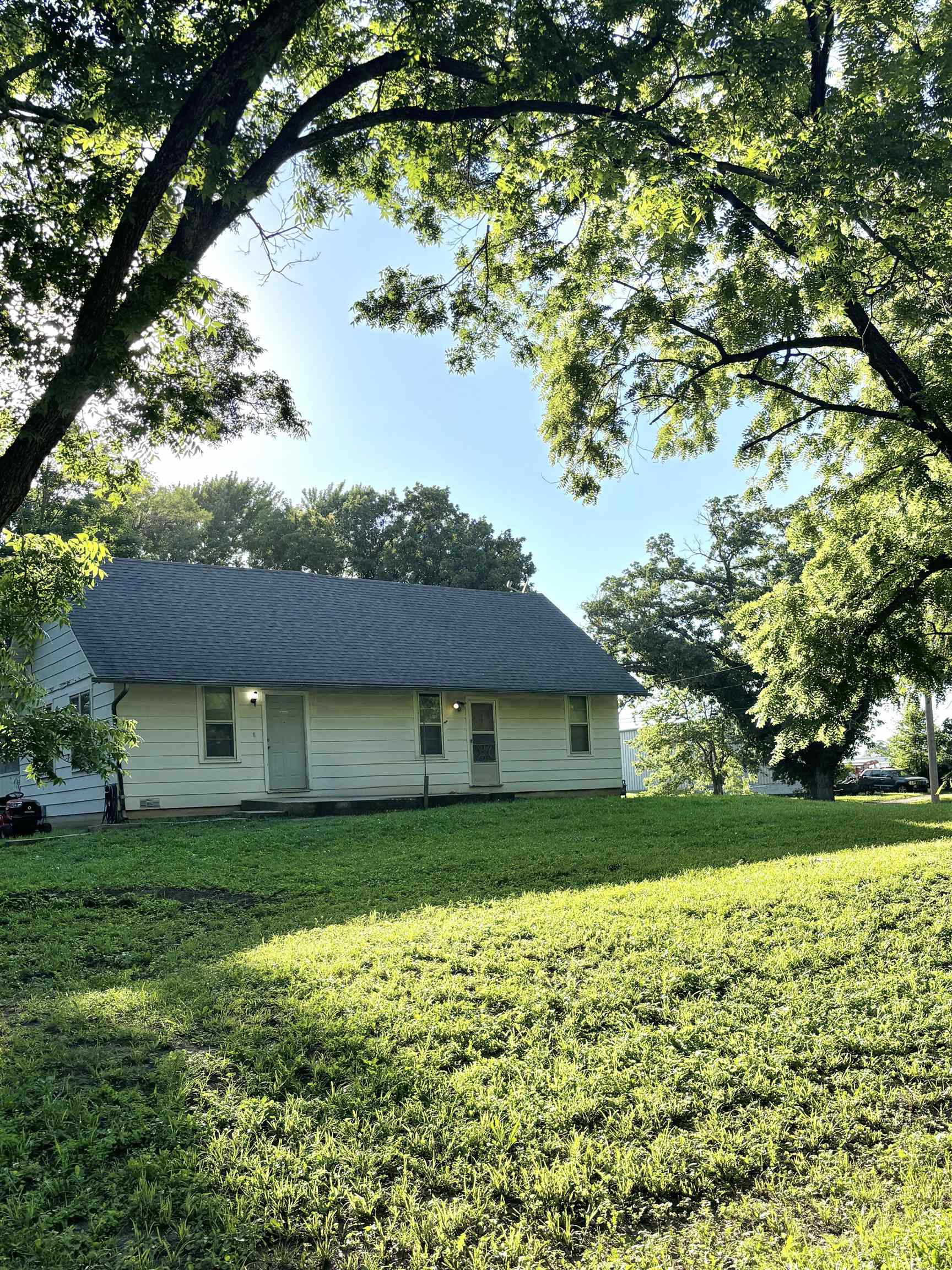 Calling all INVESTORS!!!!!This cozy 3-bedroom, 1-bath home offers 1,032 square feet of comfortable living space with some thoughtful updates. Great opportunity for investors or homeowner.  Sitting on a large corner lot with a wrap around driveway adds convenience, extra parking, and easy acces! This home has some great updates already done for you, including beautiful laminate flooring in the nice sized living/dining room, kitchen, & hallway. The gas range is included for you! There's lots of new, modern  light fixtures and a completely renovated bathroom with a new, shower, bathtub, toilet, sink, wiring, plumbing, and fixtures.The third bedroom has it's own entrance, vinyl flooring and washer & dryer hook ups! Central heat and air keep you comfortable year round. Enjoy relaxing mornings or quiet evenings on the screened-in back porch. Outside, the wrap-around driveway adds convenience, extra parking, and easy access. The large lot has plenty of room for a garden or family and friends to gather for games and fun. This home is a great opportunity for buyers looking for an affordable property and is currently rented with a month to month lease. Schedule your appointment today. Add to your rental portfolio - the sellers of this property also own the properties in El Dorado at 721 N. Star St. and 521 S. Topeka and would consider a package sale of these listed properties! Set up your private showing today!