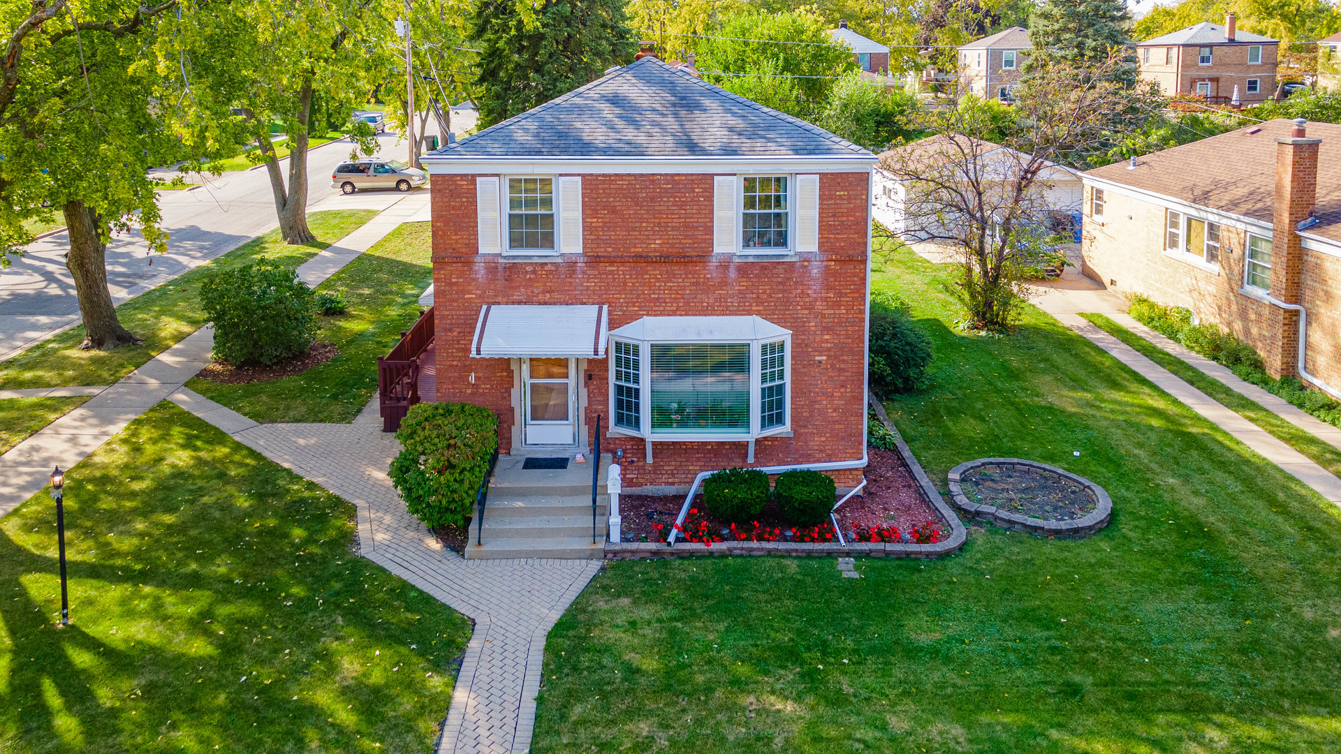 Gorgeous brick Georgian sitting on an expansive corner lot. The property features 5 bedrooms and 2 bathrooms, and a spacious addition. The property features: beaming oak hardwood floors throughout, a new kitchen with quartz countertops, new baths with porcelain tile, and new thermal windows throughout. All new electricity, plumbing, drywall, bathrooms, and A/C (2022); furnace/humidifier (2021); roof/gutters/gutter guards (2020); large Trex deck; 2 car garage with exterior parking pad adjacent fitting 4 more cars; brick paved entrance with professional landscaping. Do not miss out on this beauty!