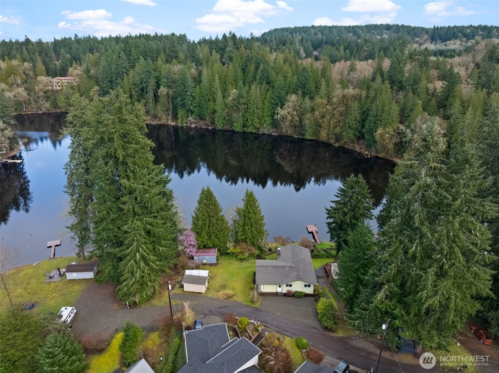 First time on the market! Enjoy expansive waterfront footage with 150 feet of private lakefront on Lake St. Clair. Direct water access via terraced steps or a gentle side slope. This 2,400 sq ft daylight basement home is solid and full of potential, ready for your personal refresh, featuring solid wood cabinetry throughout. Situated on two parcels, the property offers a serene, peaceful setting on a no-wake lake, ideal for swimming, fishing, kayaking, paddleboarding, small motor boating, and bird watching. Located at the end of a quiet community with plenty of parking, including space for an RV. The owner left the existing dock in place to potentially avoid the need for permitting a new one.