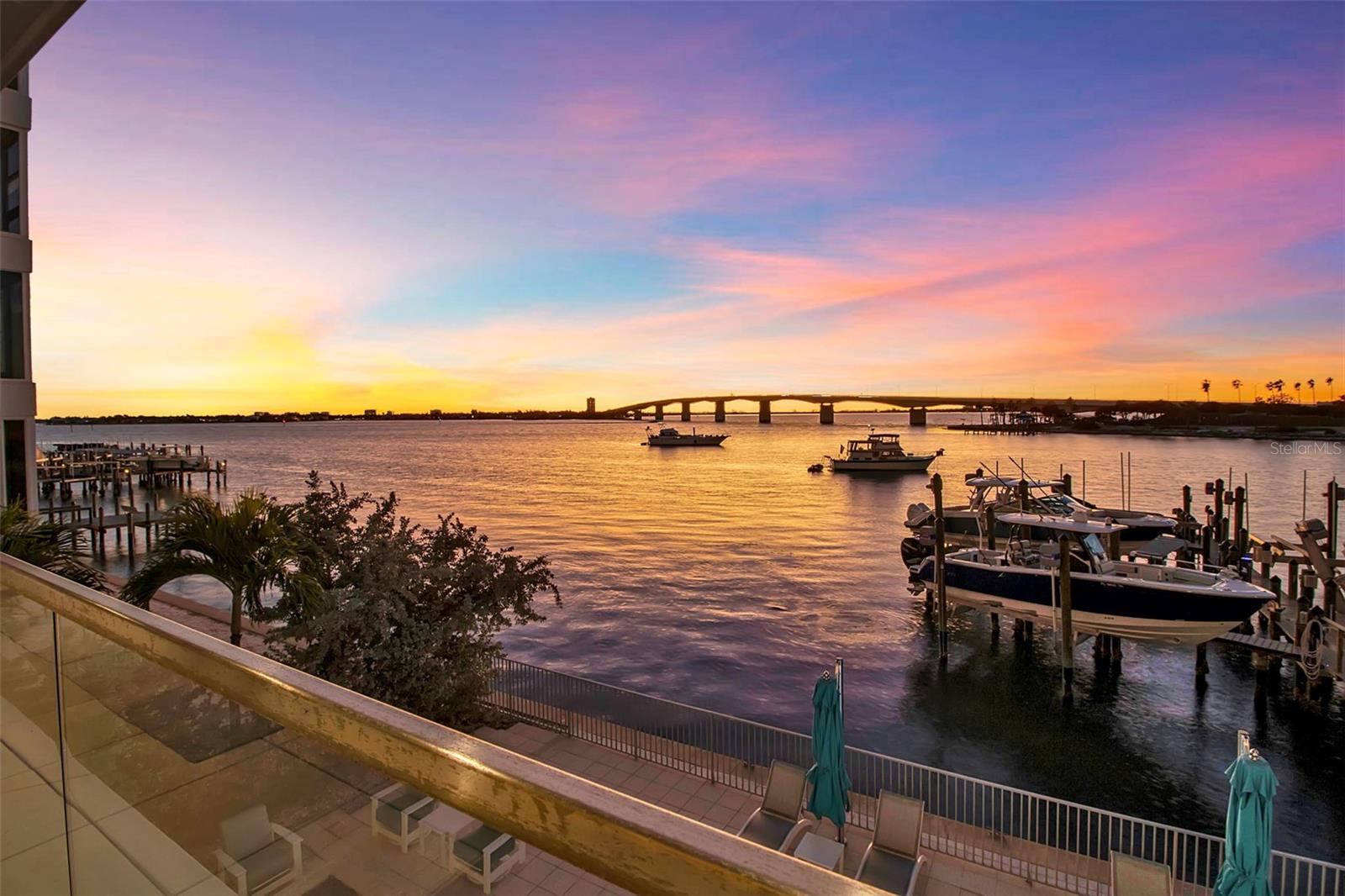 Under contract-accepting backup offers. Modern waterfront sophistication takes center stage in this exceptional residence at One88 on Golden Gate Point, a boutique architectural landmark offering just eight private condominiums on Sarasota Bay. Widely regarded as one of Sarasota’s most exclusive addresses, One88 delivers a rare combination of privacy, design distinction, and unobstructed bayfront living. Upon entering the residence, a refined yet highly functional interior unfolds, thoughtfully curated with premier materials and bespoke craftsmanship throughout. Distinguishing features include DuChâteau engineered wood flooring, custom Italian cabinetry by Cucine Ricci, and striking architectural concrete elements by Ben Nettles—featured in the fireplaces, kitchen breakfast bar, and powder bath sink. Additional enhancements include recessed baseboards, two alcohol-burning fireplaces, and a temperature-controlled, 500-bottle wine cellar designed for the serious collector. A full smart-home ecosystem by Wicked Smart Homes seamlessly integrates motorized window treatments, lighting, and surround sound, elevating both convenience and lifestyle. The open-concept kitchen is anchored by a premium Thermador appliance suite, including a dedicated 75+ bottle wine column, complemented by designer Italian cabinetry, a statement tile backsplash, expansive island seating, and a custom-organized walk-in pantry. Positioned to capture sweeping bay views, the kitchen flows effortlessly into the great room, framed by floor-to-ceiling glass doors that open to a 575-square-foot westerly waterfront terrace—creating an exceptional indoor-outdoor living experience unique to this residence with a built-in gas grilling area. As well as 254 sq ft of private Eastern- facing terrace space off the owner’s suite. Secured elevator access into the unit’s foyer, with an additional locking glass door for extra security. The great room offers generous flexibility for furnishing and entertaining, enhanced by a built-in wet bar with dual beverage drawers. The owner’s suite serves as a tranquil retreat, featuring a private morning terrace and a custom spa-style bath unlike any other in the building. Two additional en-suite guest bedrooms, a well-appointed powder room, a spacious laundry room, and multiple storage closets complete the interior layout. This offering includes a private boat dock equipped with a rare 25,000-pound lift, along with two side-by-side parking spaces—one with an additional car lift—plus a utility lift and substantial private storage. Residents of One88 enjoy exclusive amenities including a rooftop terrace, waterfront fire pit, bicycle storage, garage carwash station, and a 70-foot lap pool overlooking Sarasota Bay. Ideally situated on Golden Gate Point, this extraordinary residence is just minutes from downtown Sarasota, St. Armand's Circle, Lido Key, Longboat Key, and Sarasota-Bradenton International Airport—offering unparalleled access to the region’s cultural, culinary, and coastal lifestyle.