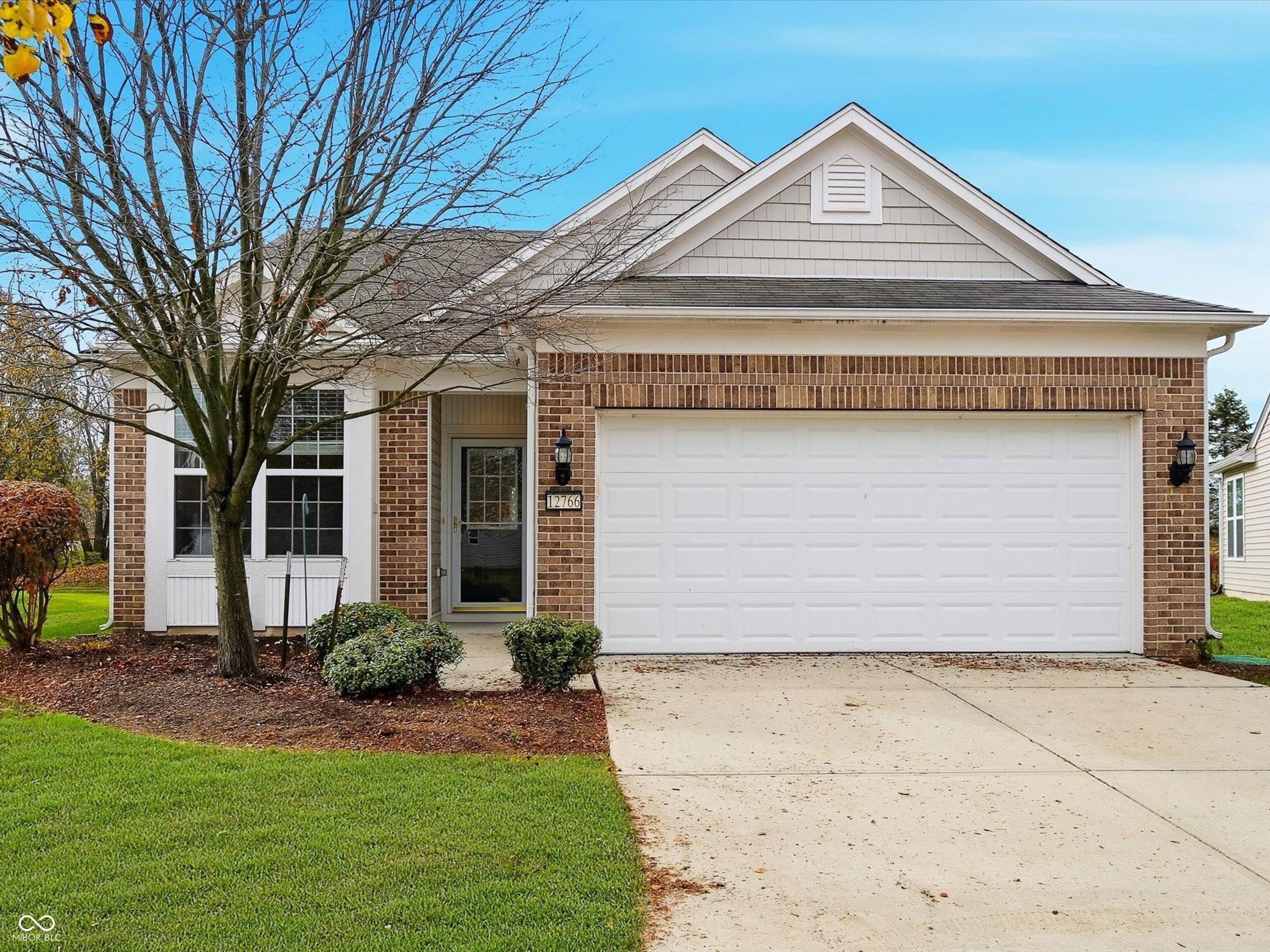 Welcome to this beautifully maintained single owner, 2-bedroom home with a den, perfectly placed on a quiet lot backing up to mature trees and a private common area-offering the serene, low-maintenance lifestyle Britton Falls is known for. Step inside and immediately feel the spacious flow of the open-concept layout, where the kitchen, dining, and great room flow together effortlessly for everyday comfort and easy entertaining. The generous kitchen features abundant cabinetry, stainless steel appliances, a center island, and plenty of countertop space for prepping, serving, or gathering with friends. Just beyond, the bright sunroom-with its wall of windows-invites you to enjoy your morning coffee or unwind with a good book while overlooking the tree-lined walking path. The primary suite is thoughtfully designed with a large walk-in closet, double-sink vanity, and a walk-in tub, ideal for comfort, accessibility, and relaxation. A spacious second bedroom and a front flex room provide the perfect setup for guests, hobbies, or a quiet office retreat.  Outside, the private patio offers peaceful views of mature trees and the neighborhood trail just a few steps away. Fresh interior paint, a roomy 2-car garage, and the benefit of lawn care and snow removal handled by the HOA all add to the ease of living. Britton Falls homeowners enjoy an exceptional lifestyle with resort-style amenities at The Chateau-including indoor/outdoor pools, pickleball, fitness opportunities, clubs, and special events. Conveniently close to Fishers, Fortville, and Hamilton Town Center, this location blends comfort, community, and convenience in one welcoming package. This is the perfect place to settle into the Del Webb lifestyle-relaxed, social, and wonderfully maintained.